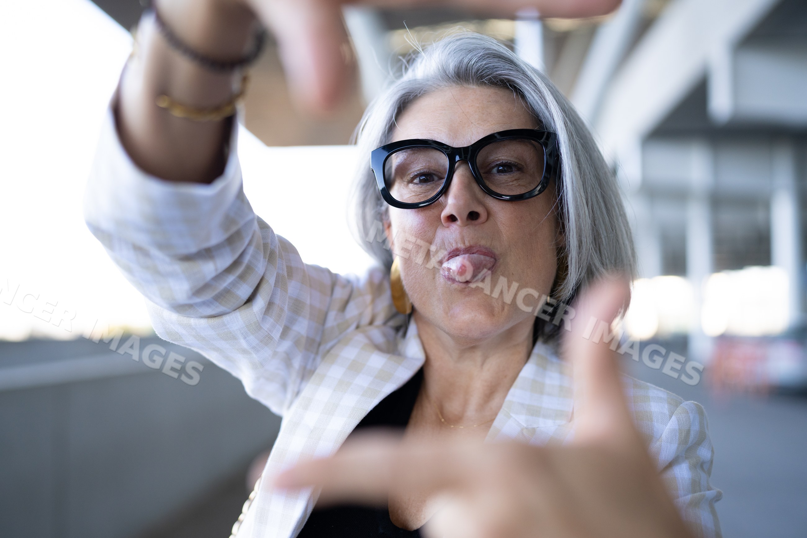 Middle-aged white woman making a framing gesture with humorous