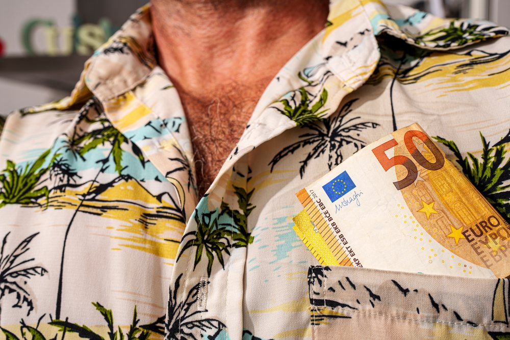 50 euro banknotes tucked in tropical print shirt pocket