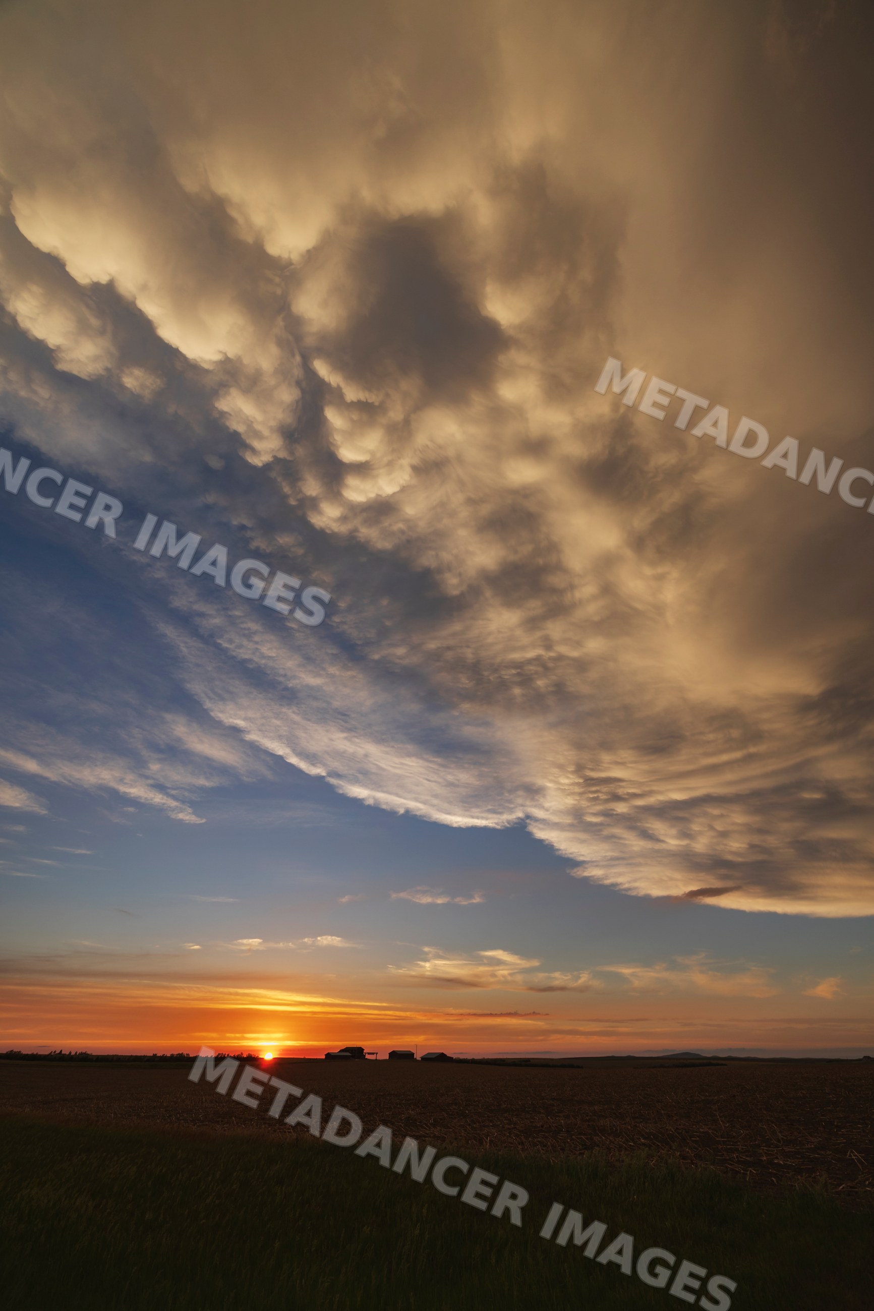 Post-Frontal Sunset with storm clouds over rural fields in winner