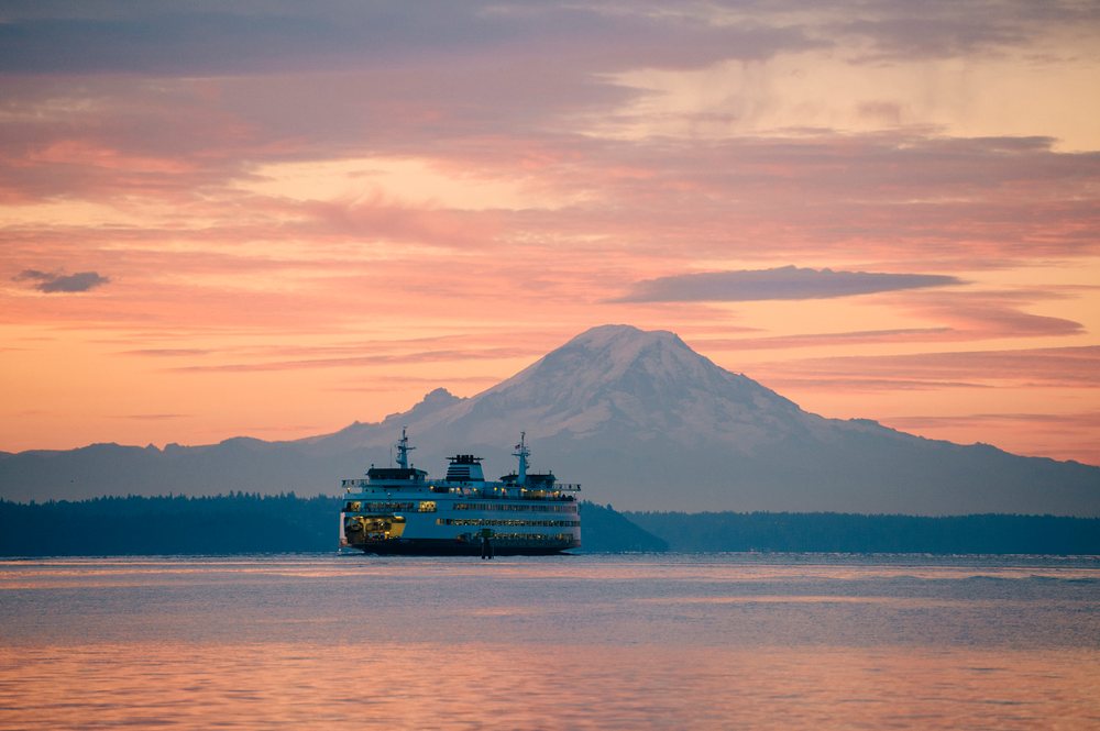 Ferry crossing water with mount rainier