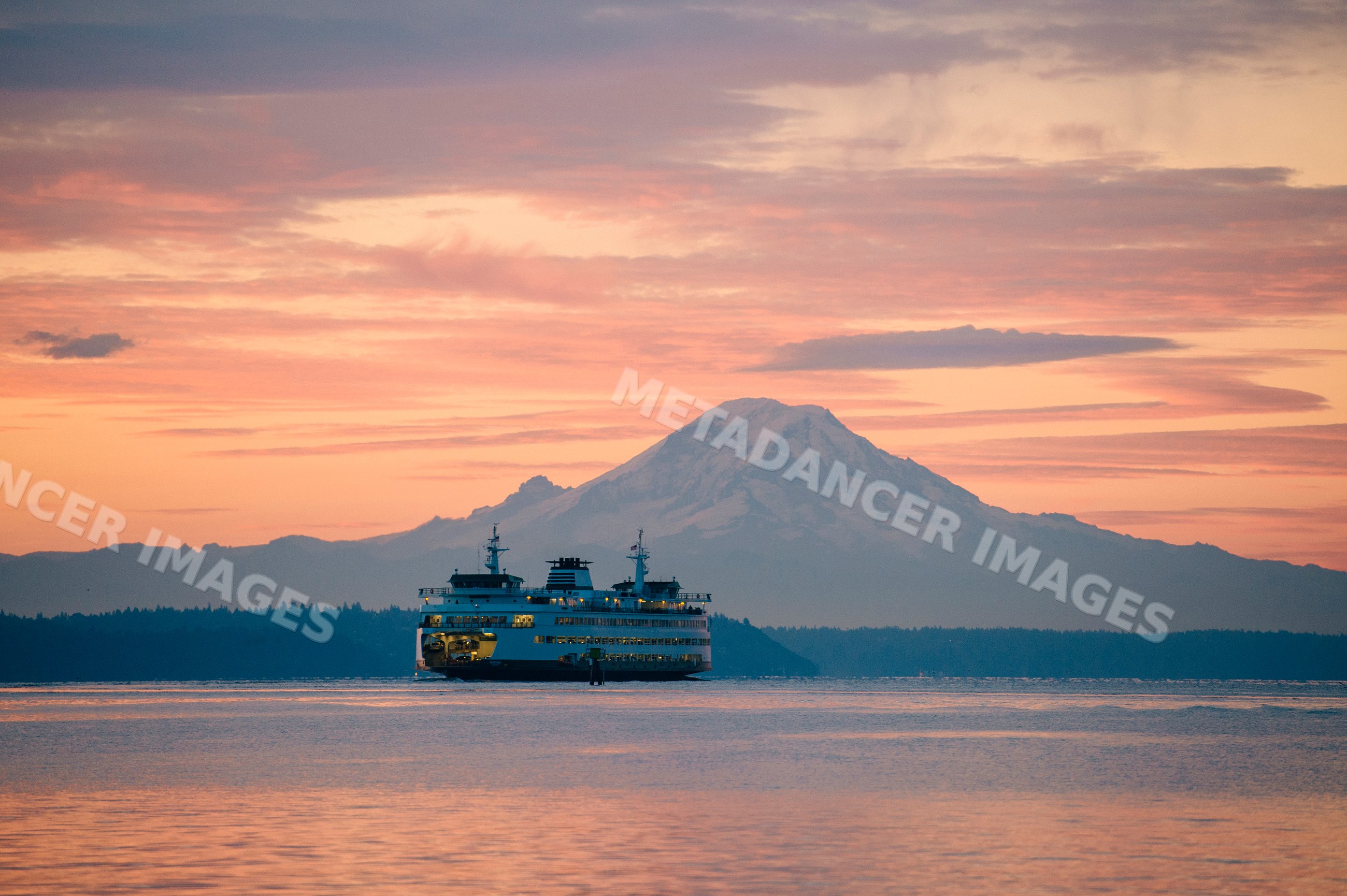 Ferry crossing water with mount rainier