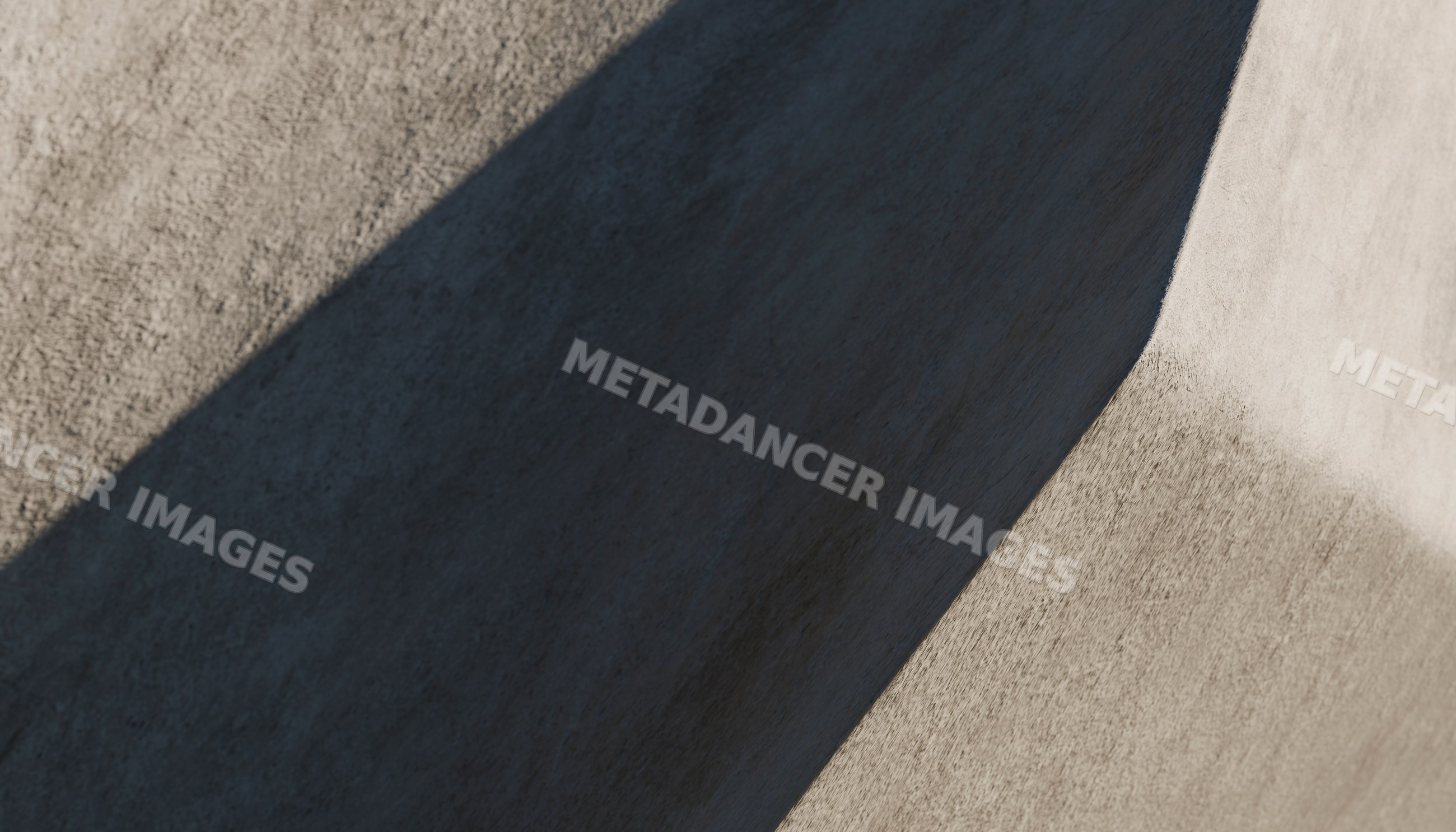 A concrete wall with curved shadow shapes and textured surface