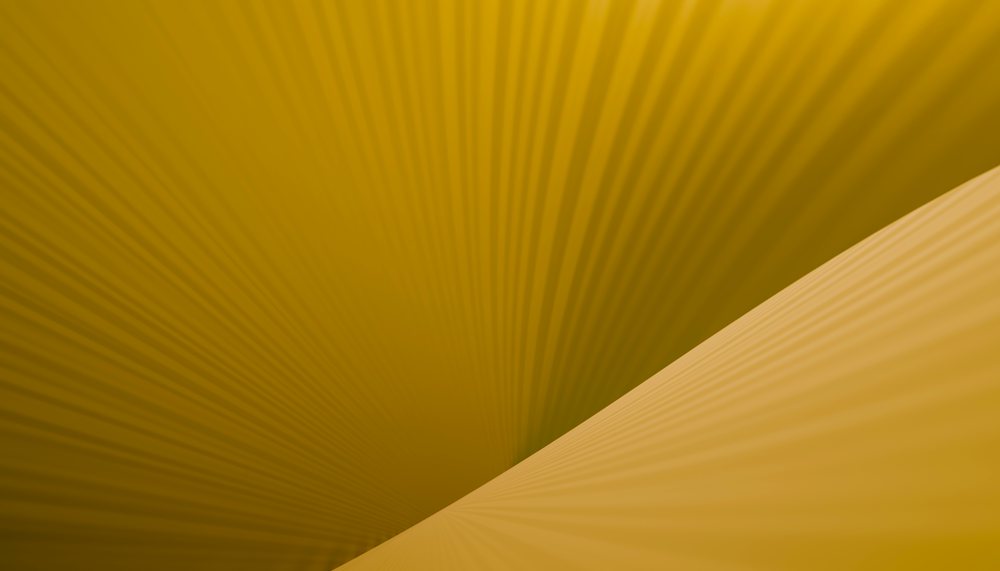Abstract yellow surface with curved diagonal lines and shadow pattern