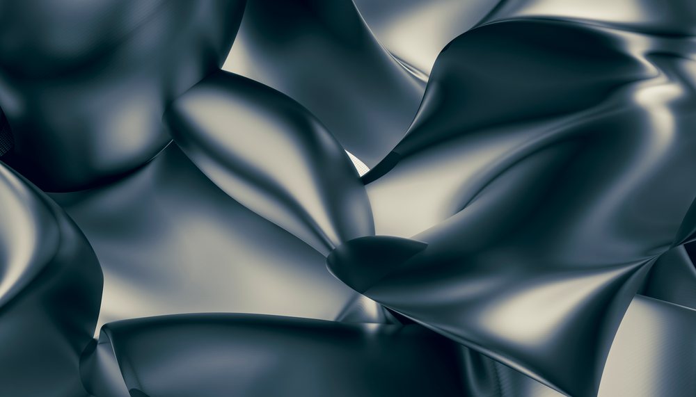 Close-up of black satin fabric with smooth shiny folds