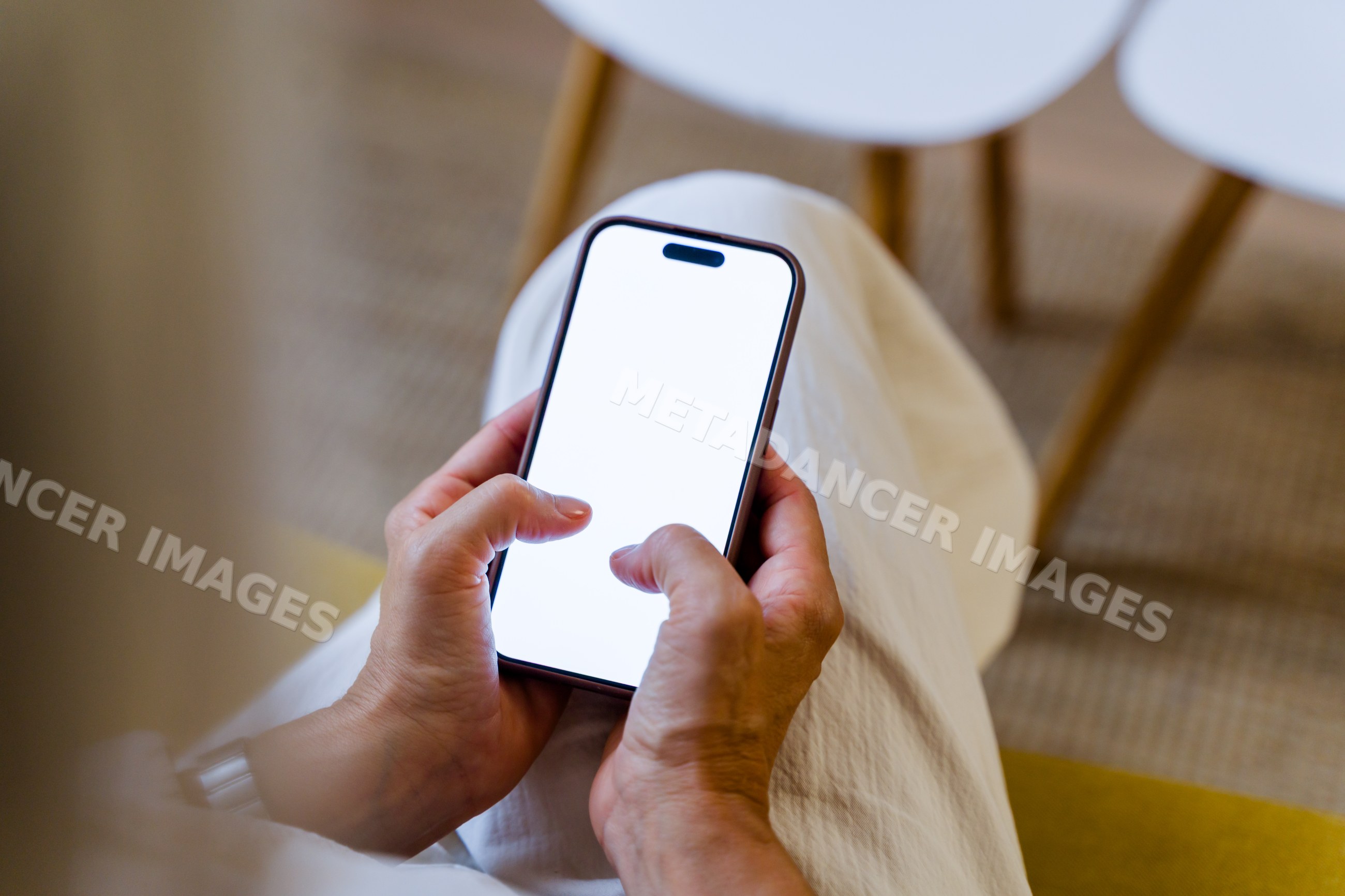 Person holding smartphone with blank white screen