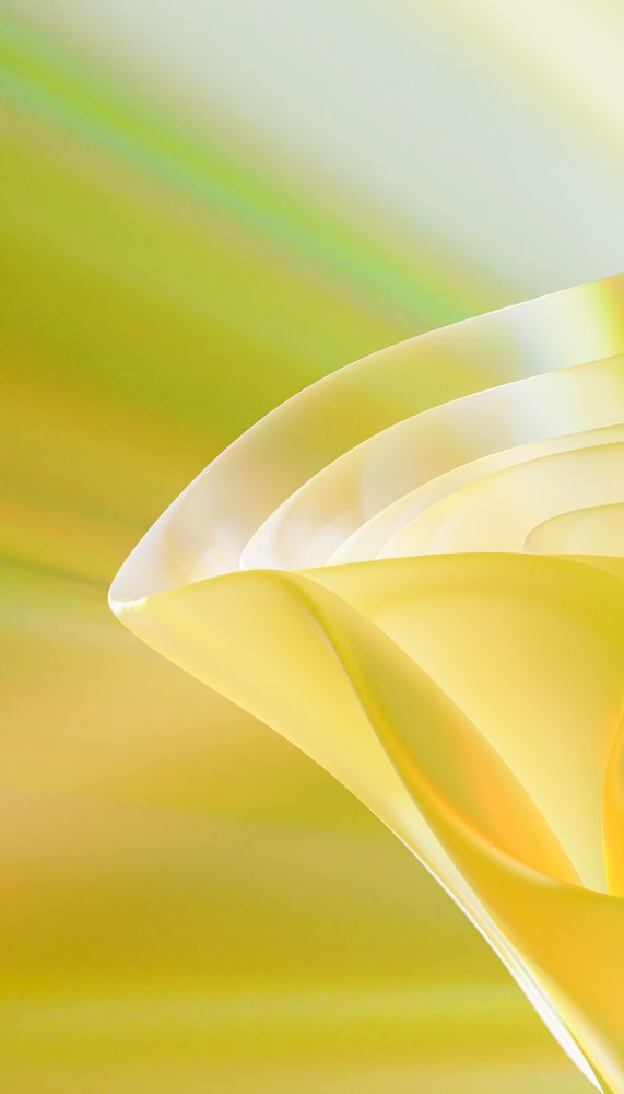Close-up of translucent yellow abstract curved shapes with smooth