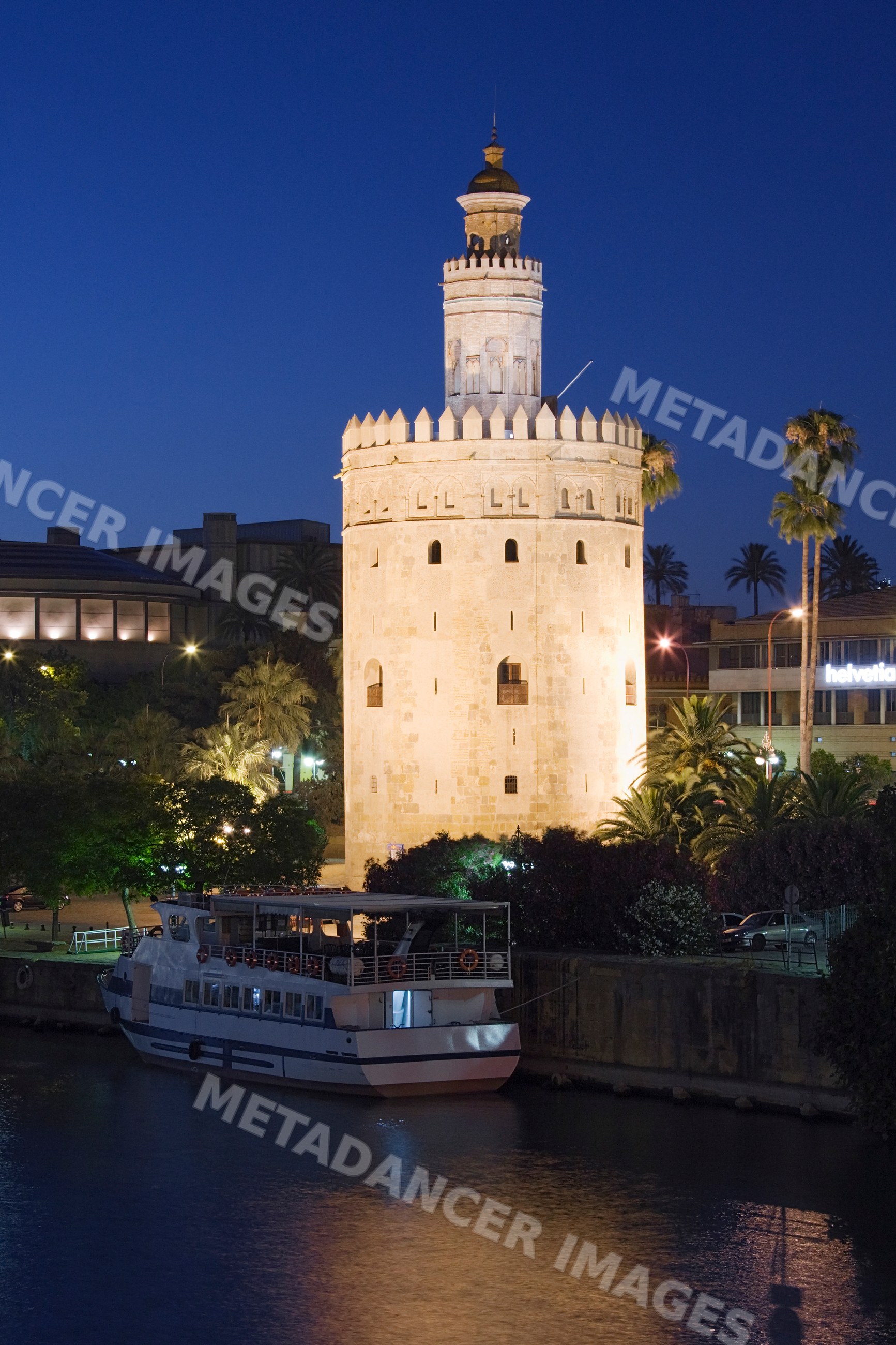 Torre del oro and guadalquivir river at night