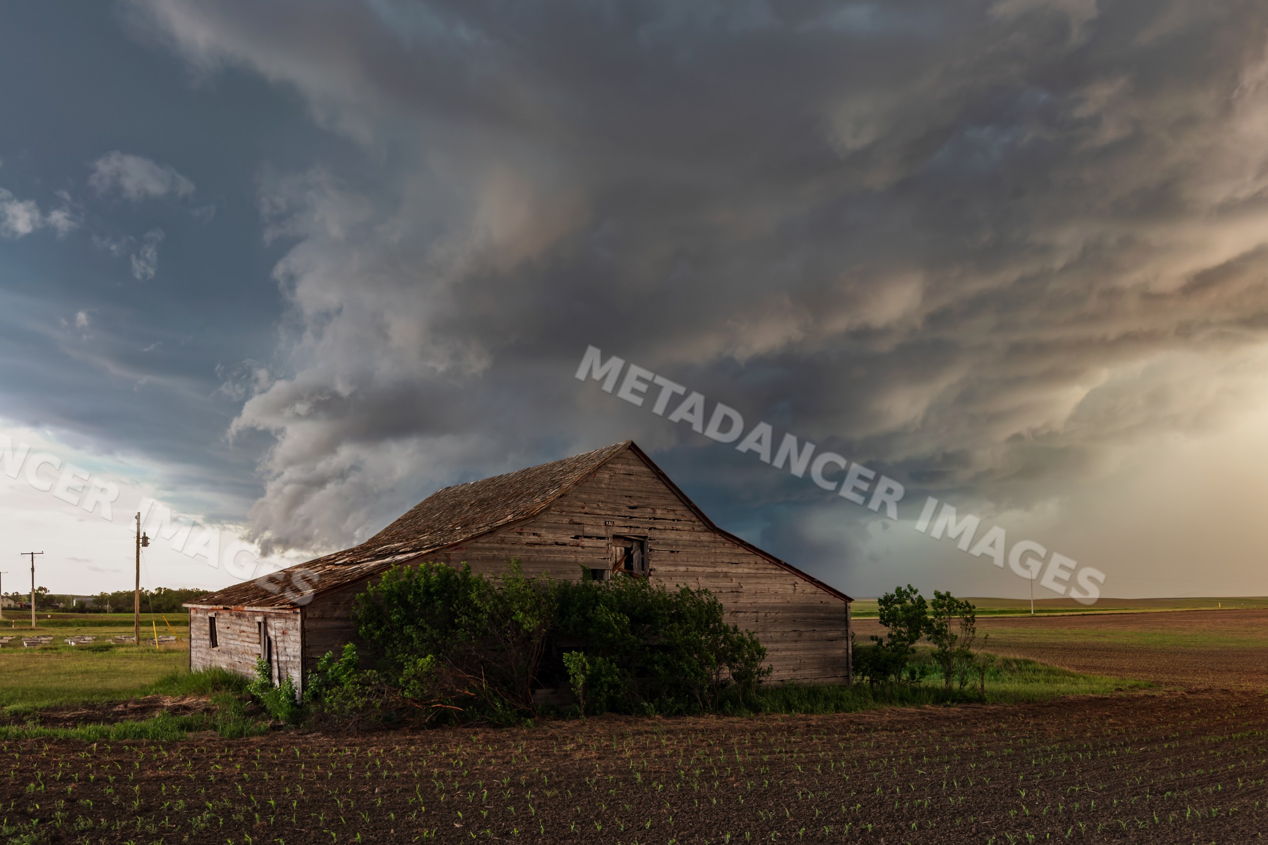 Old Barn under Storm Clouds in wood, south dakota, USA