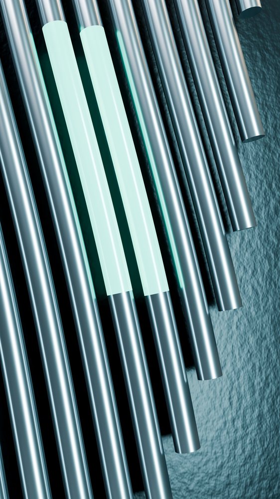 Two highlighted metal pipes among parallel steel tubes