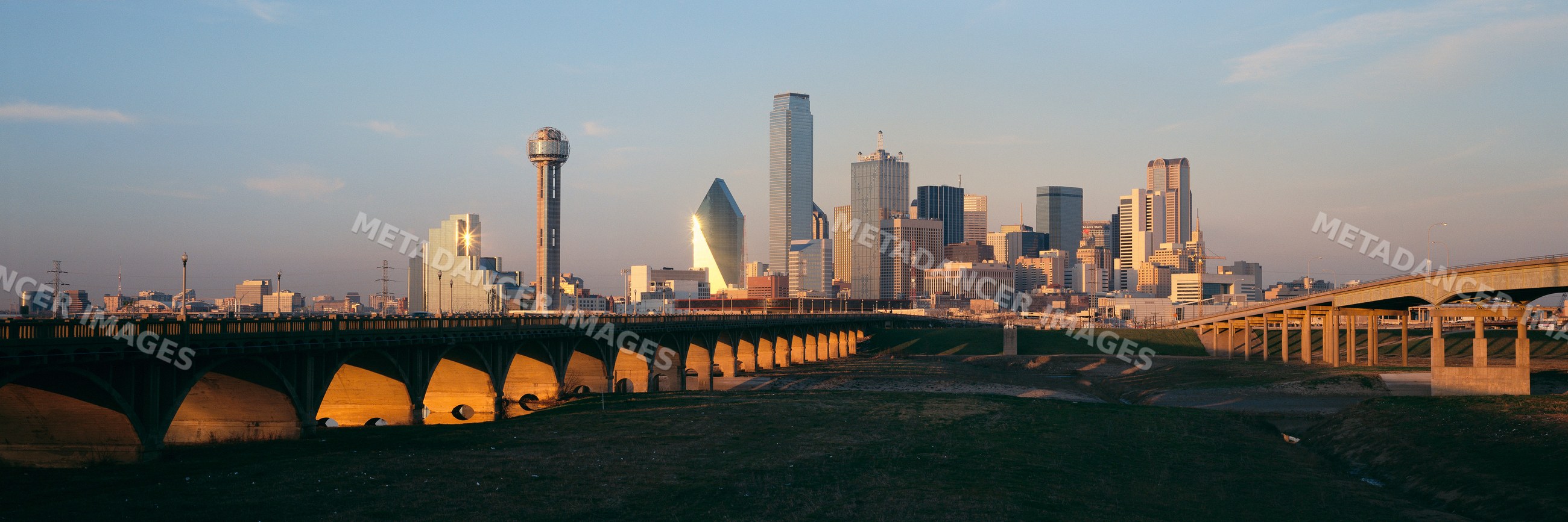 Dallas skyline with trinity river and bridges at sunset