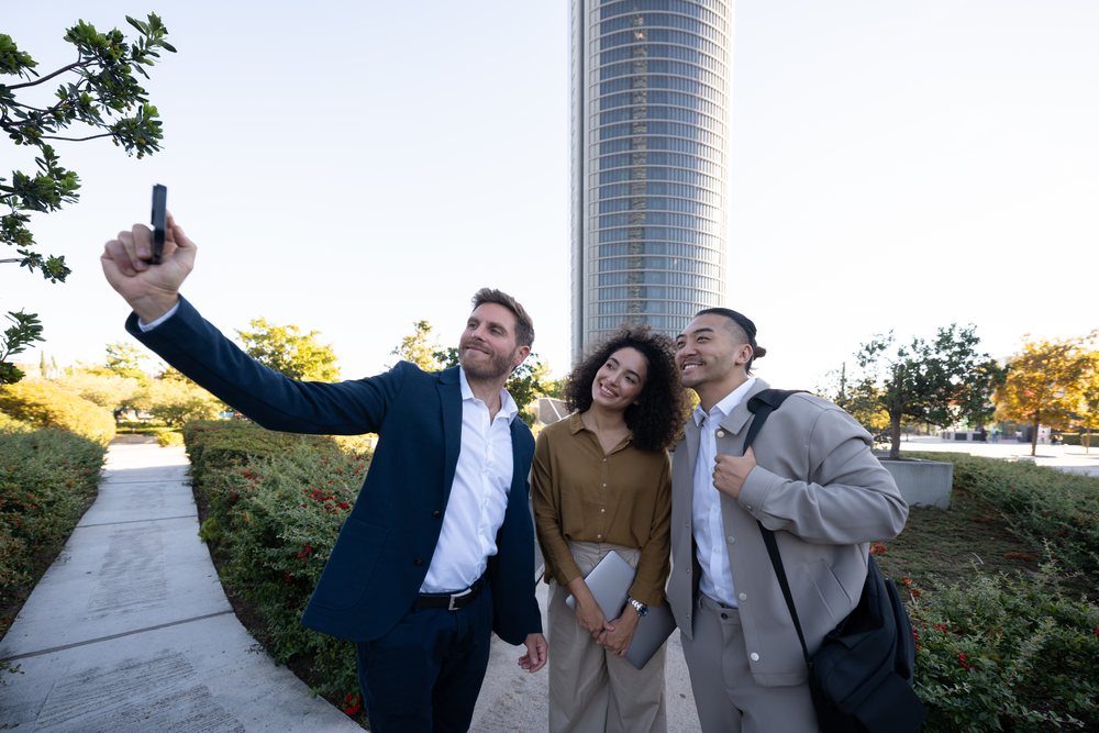Business white professionals taking selfie outdoors