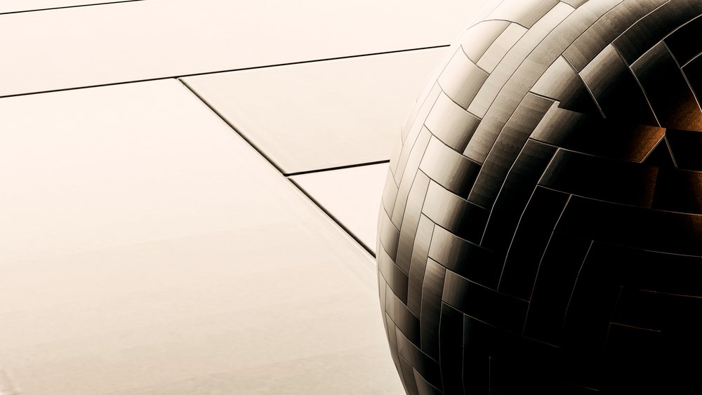 Close-up of woven metal sphere architectural sculpture outdoors