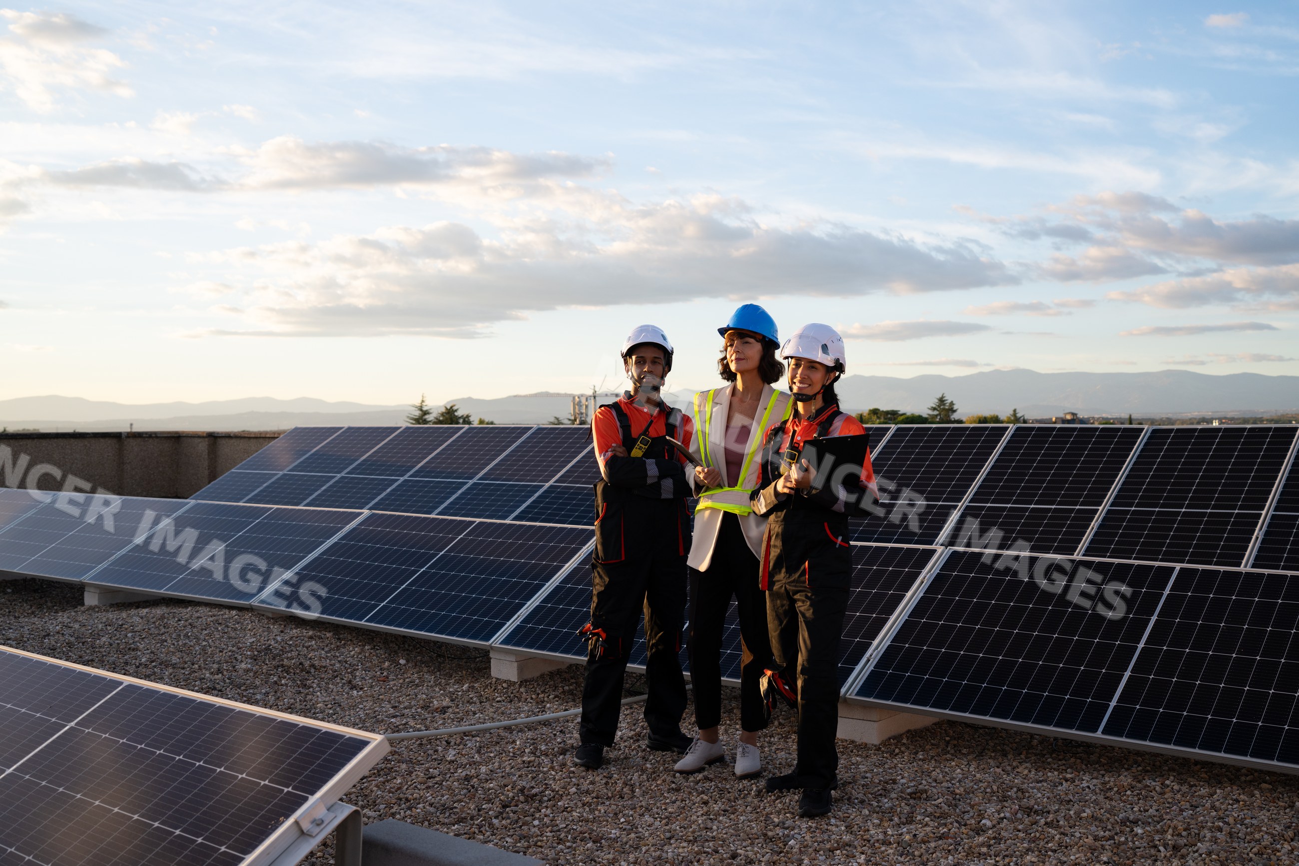 Engineers inspecting solar panels for solar energy production outdoors