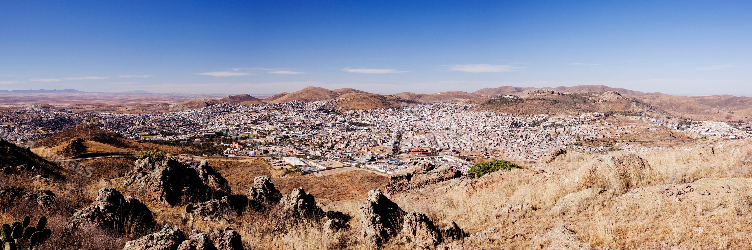 Panoramic cityscape of zacatecas with dry hills and rocky terrain