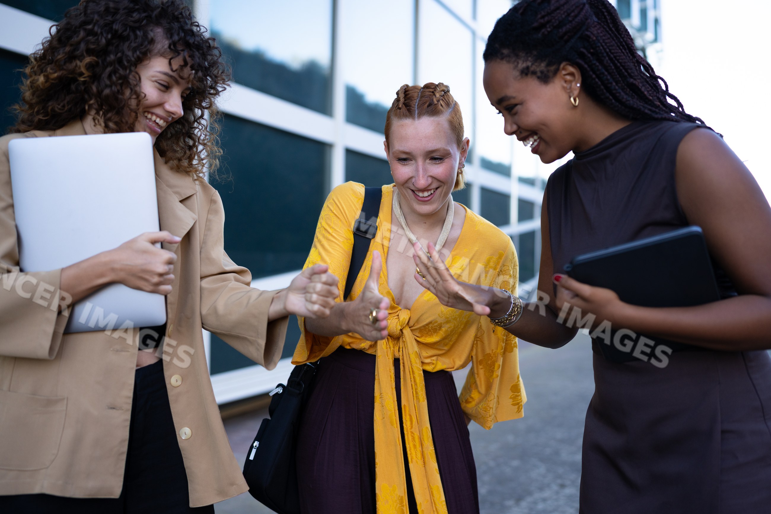 Friends playing a hand game outdoors in an urban setting
