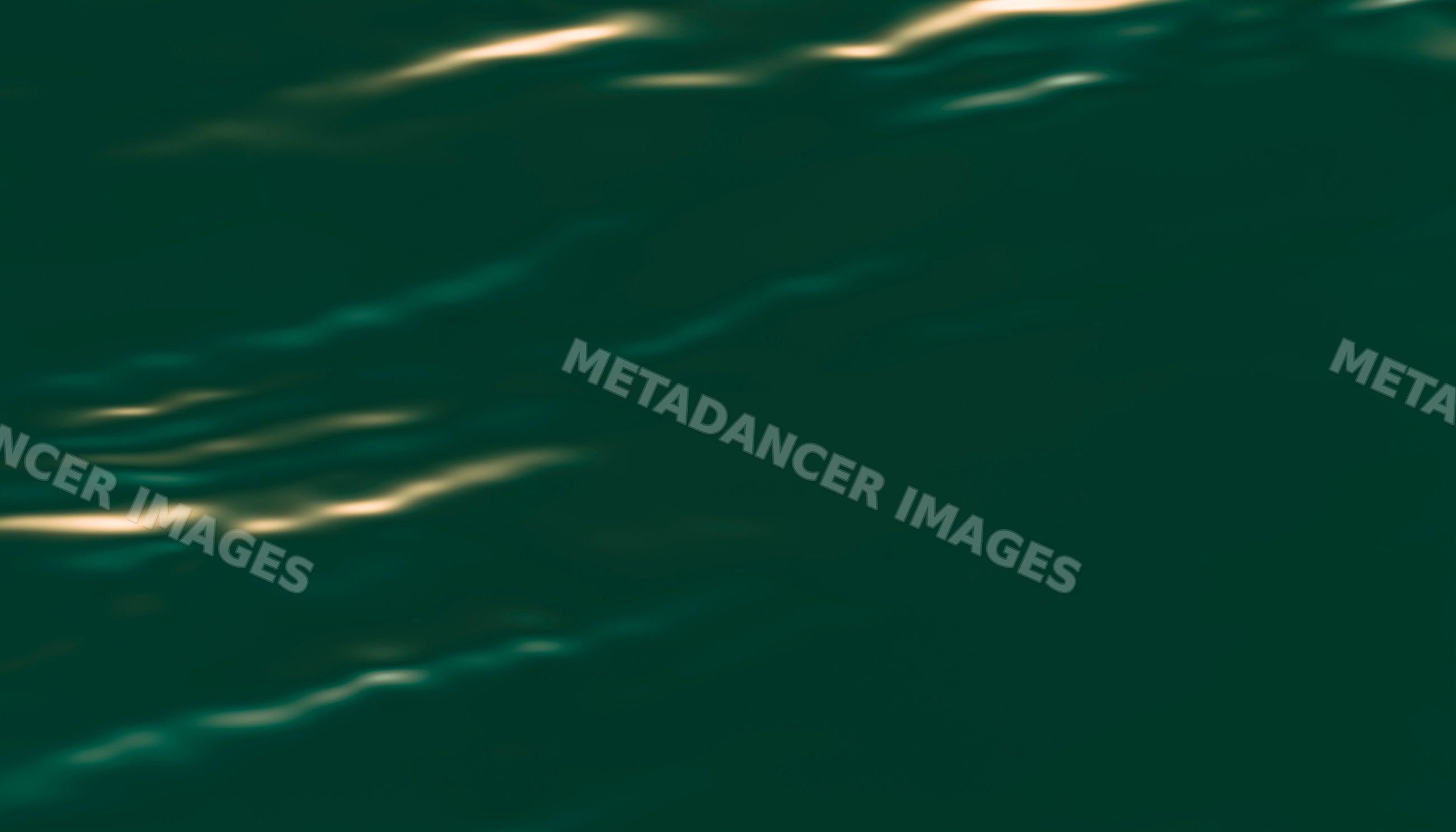 Water surface with sunlight reflecting on gentle ripples