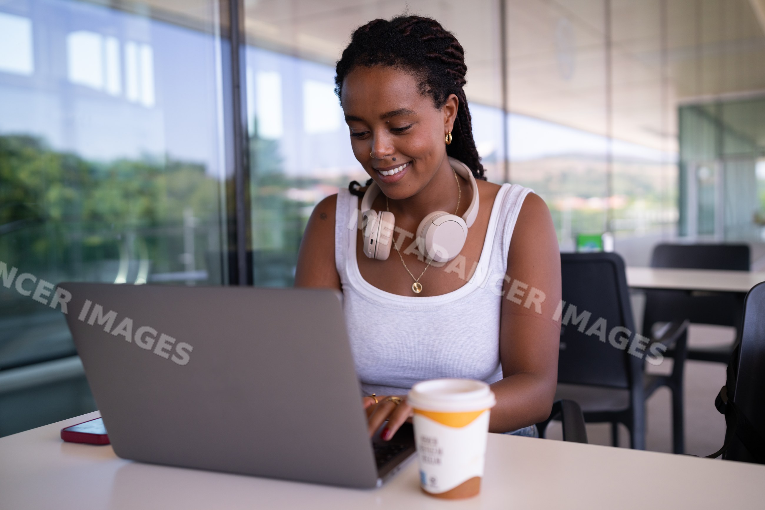 A African American woman works remotely on a laptop