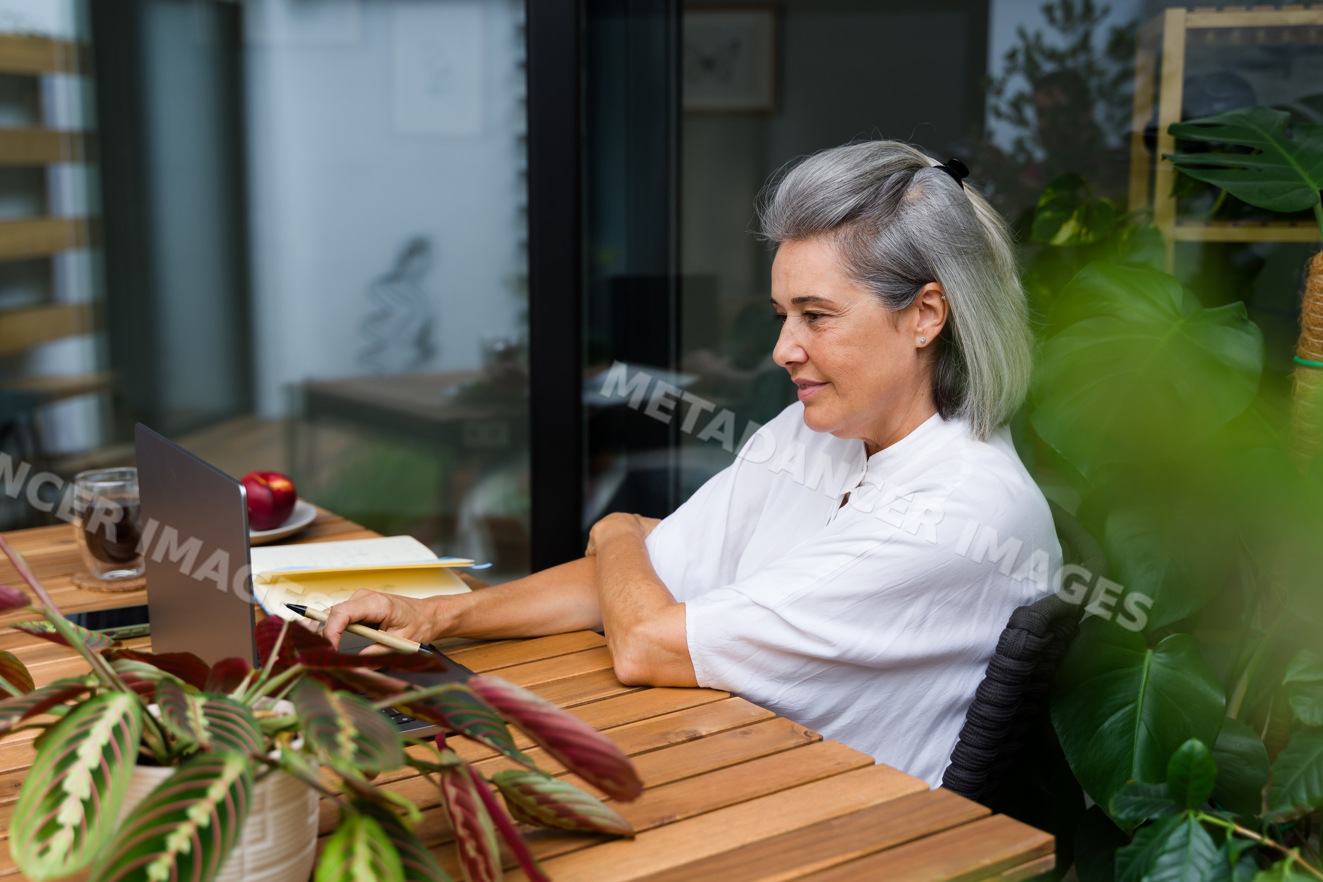 White Woman using laptop while working