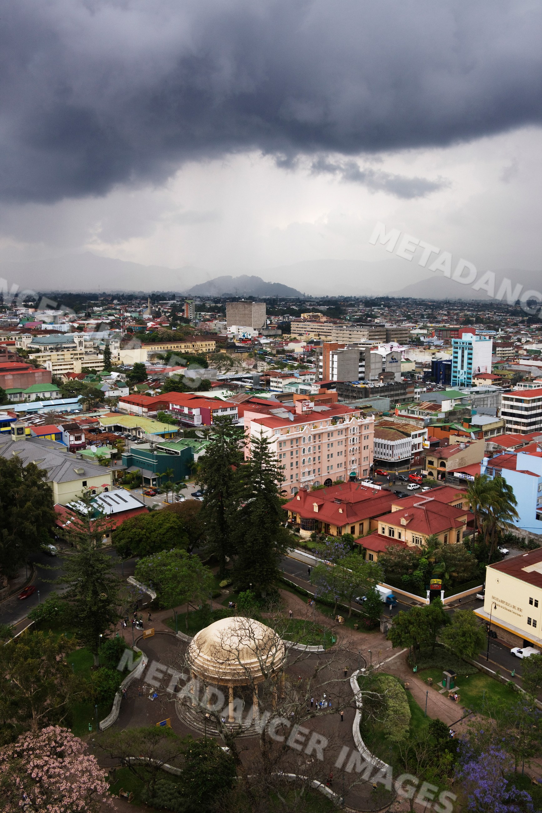 Storm clouds over san jose cityscape featuring urban park, buildings