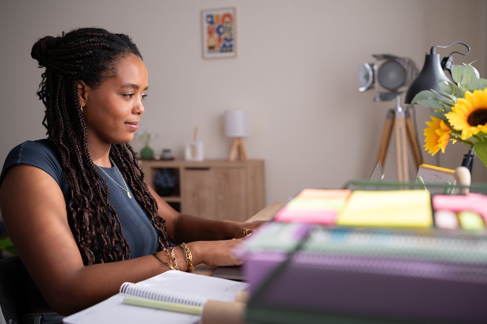 African American woman types on a laptop