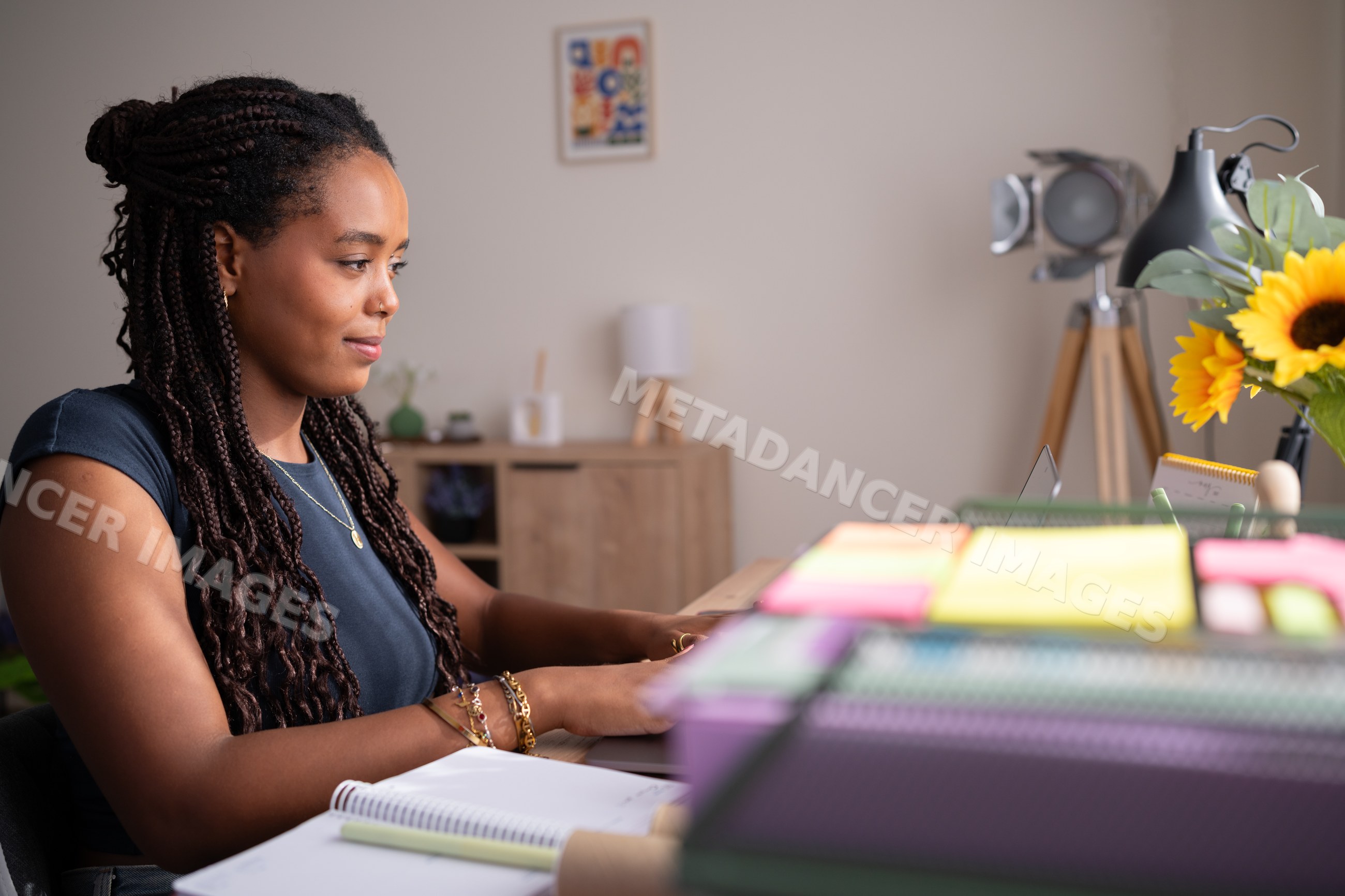 African American woman types on a laptop