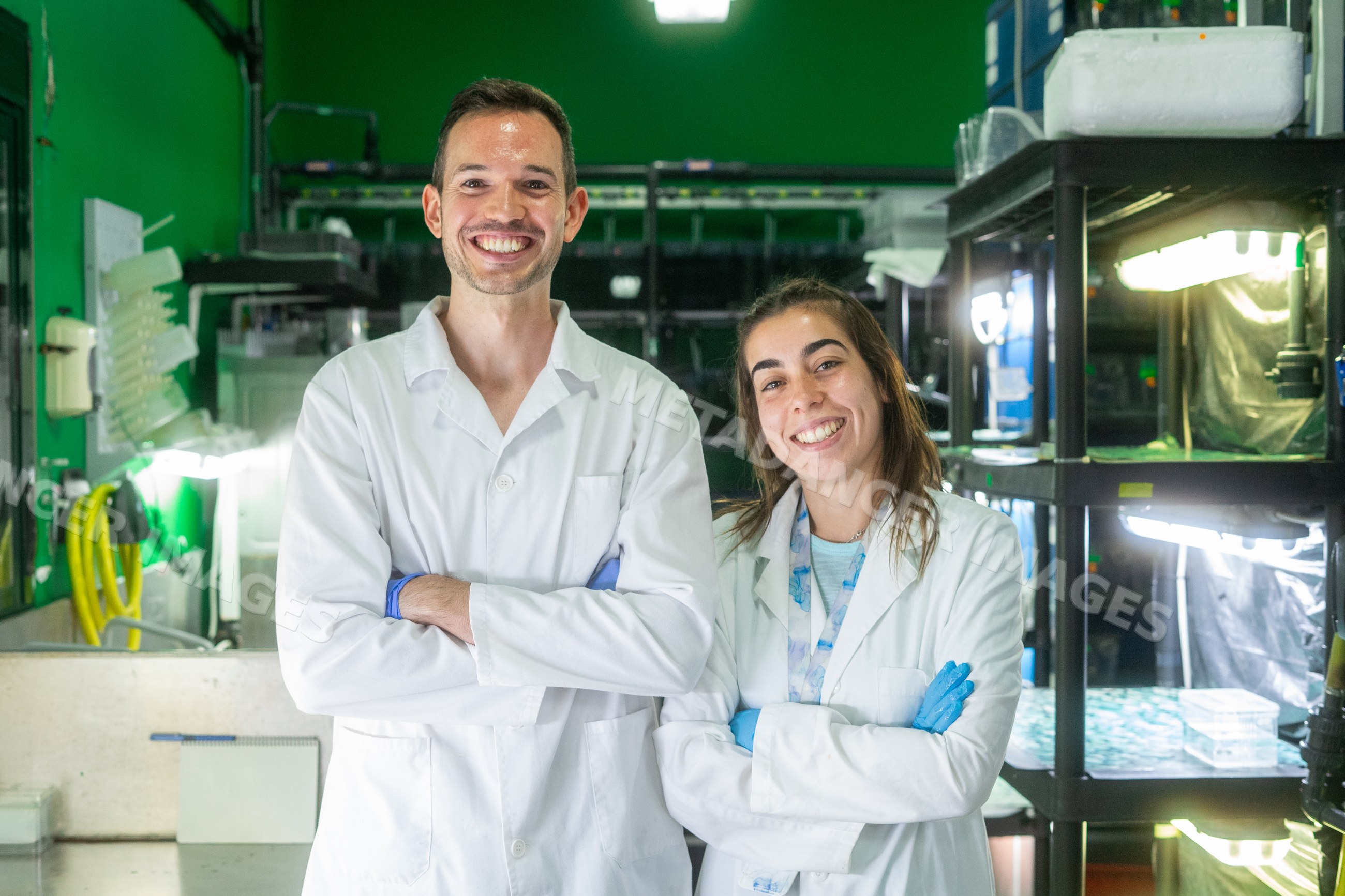 Two scientists smiling in a research laboratory in a laboratory