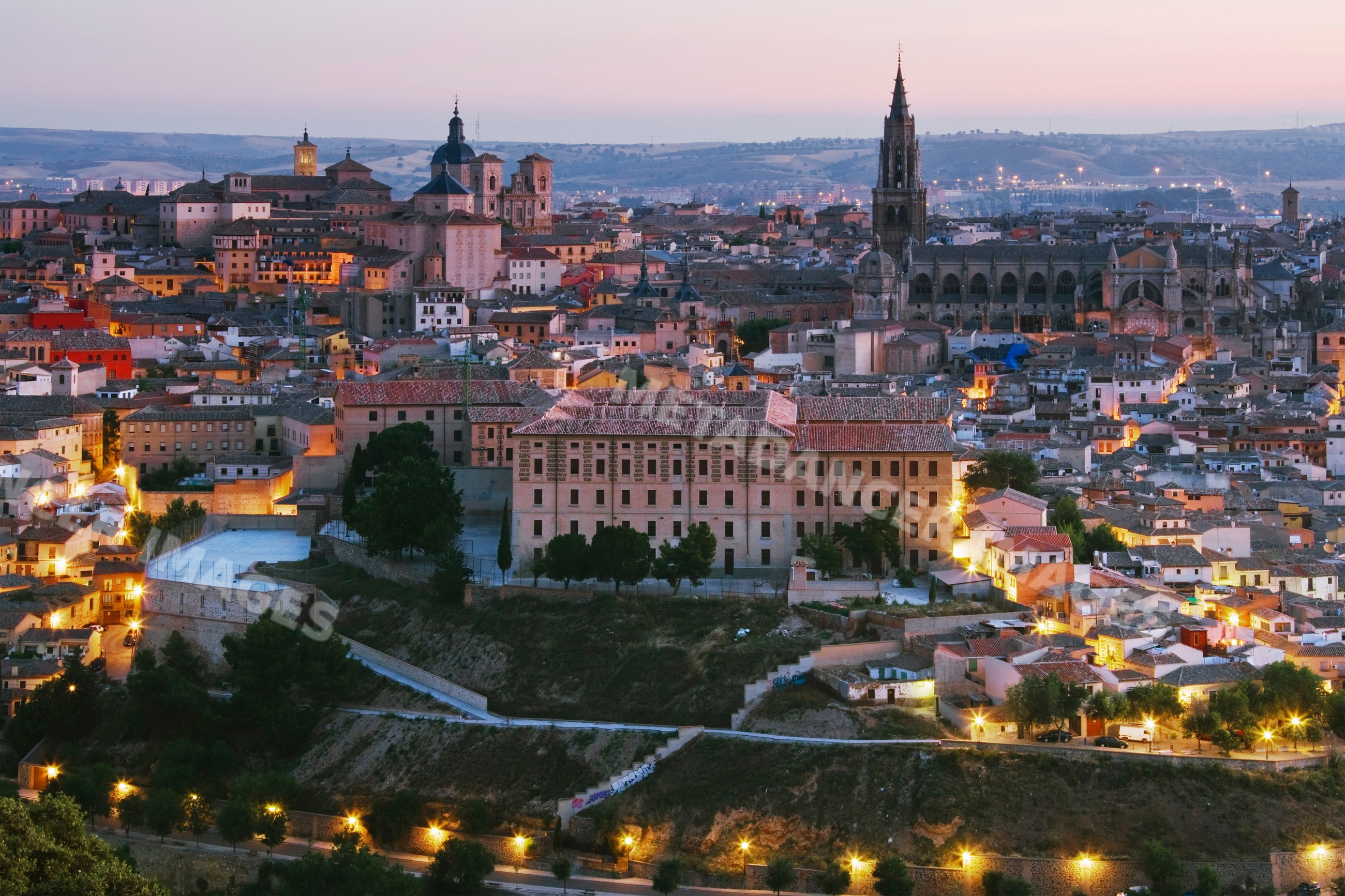 Toledo cityscape at sunset with historic cathedral and old town