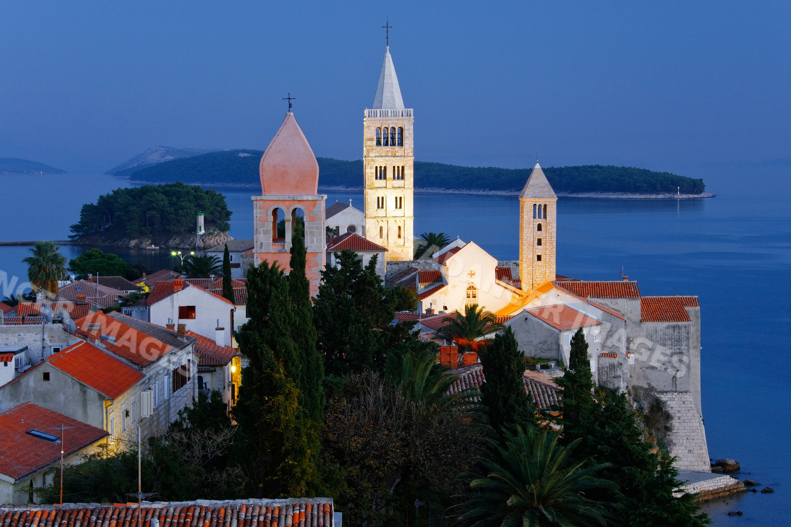 Historic church towers and tiled roofs on rab island coast