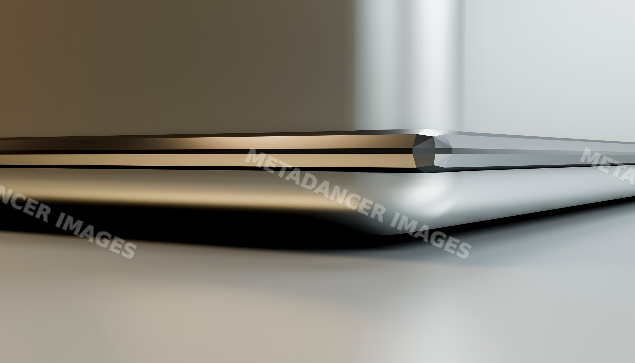Closed laptop computer with sleek metallic surface reflecting light
