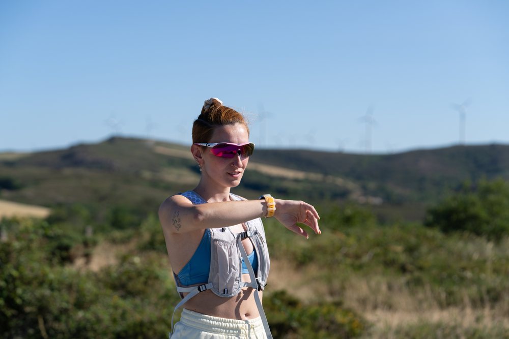 A white woman checks her fitness watch