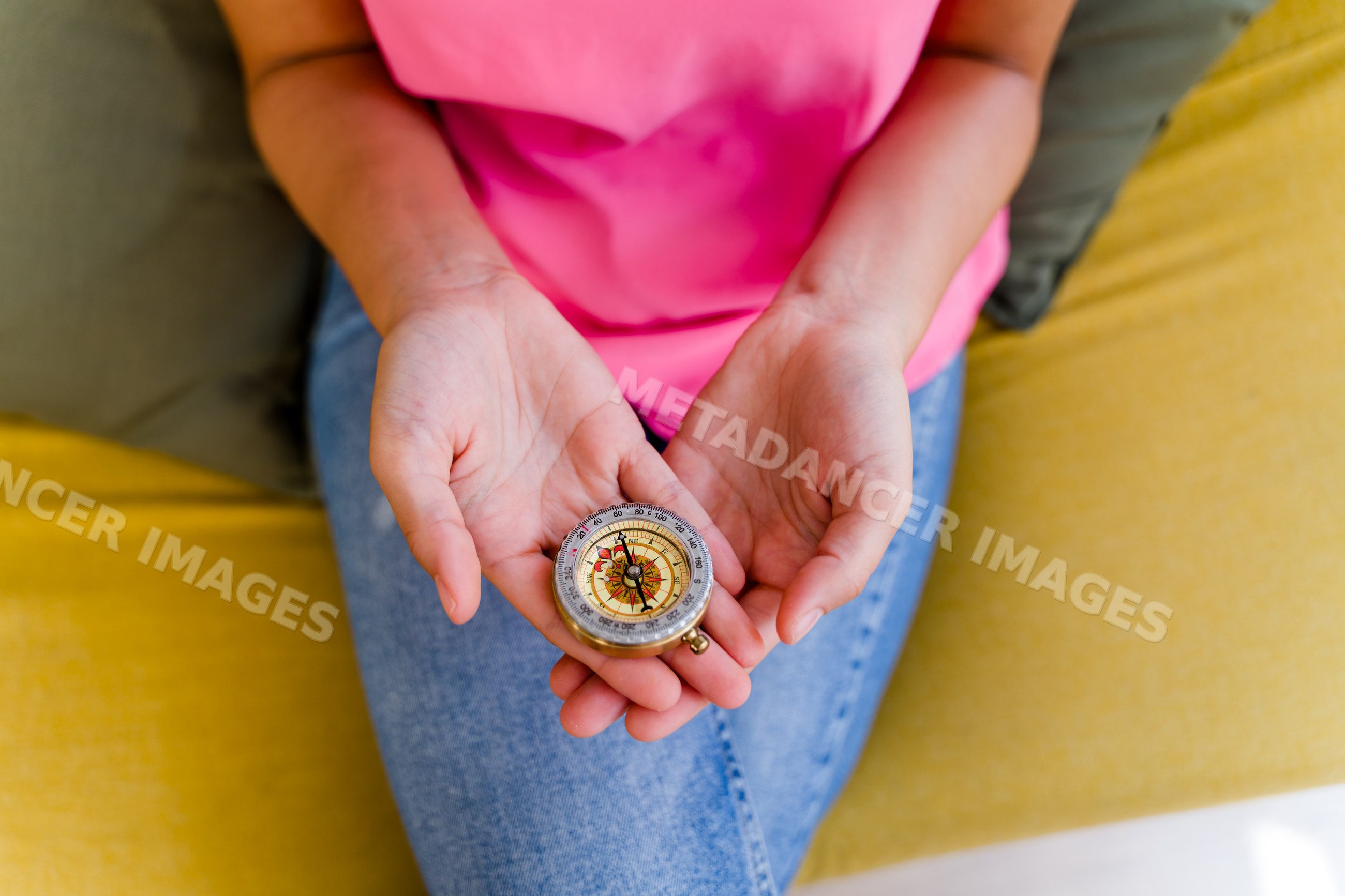 A Hispanic woman holds a compass