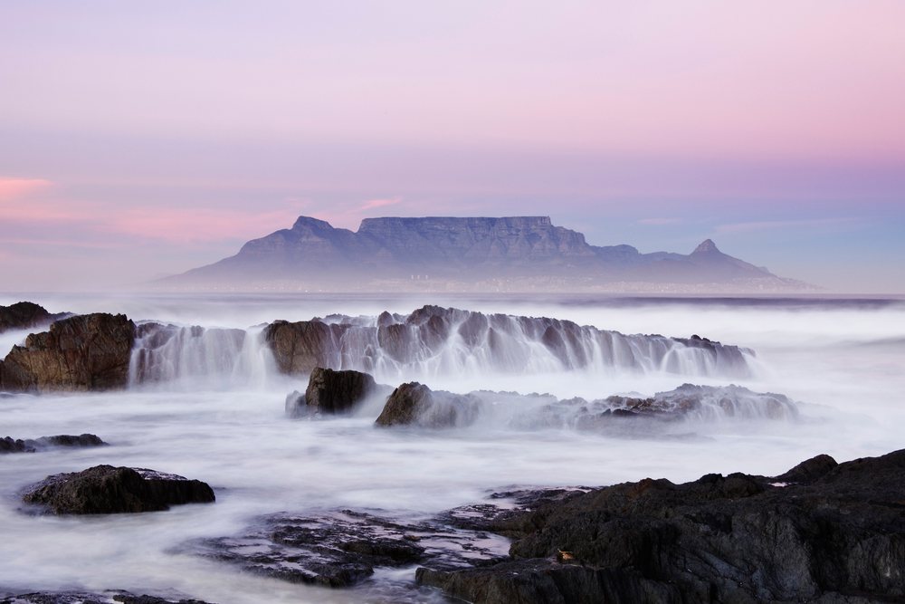 Table mountain and rocky coastline at sunset, south africa