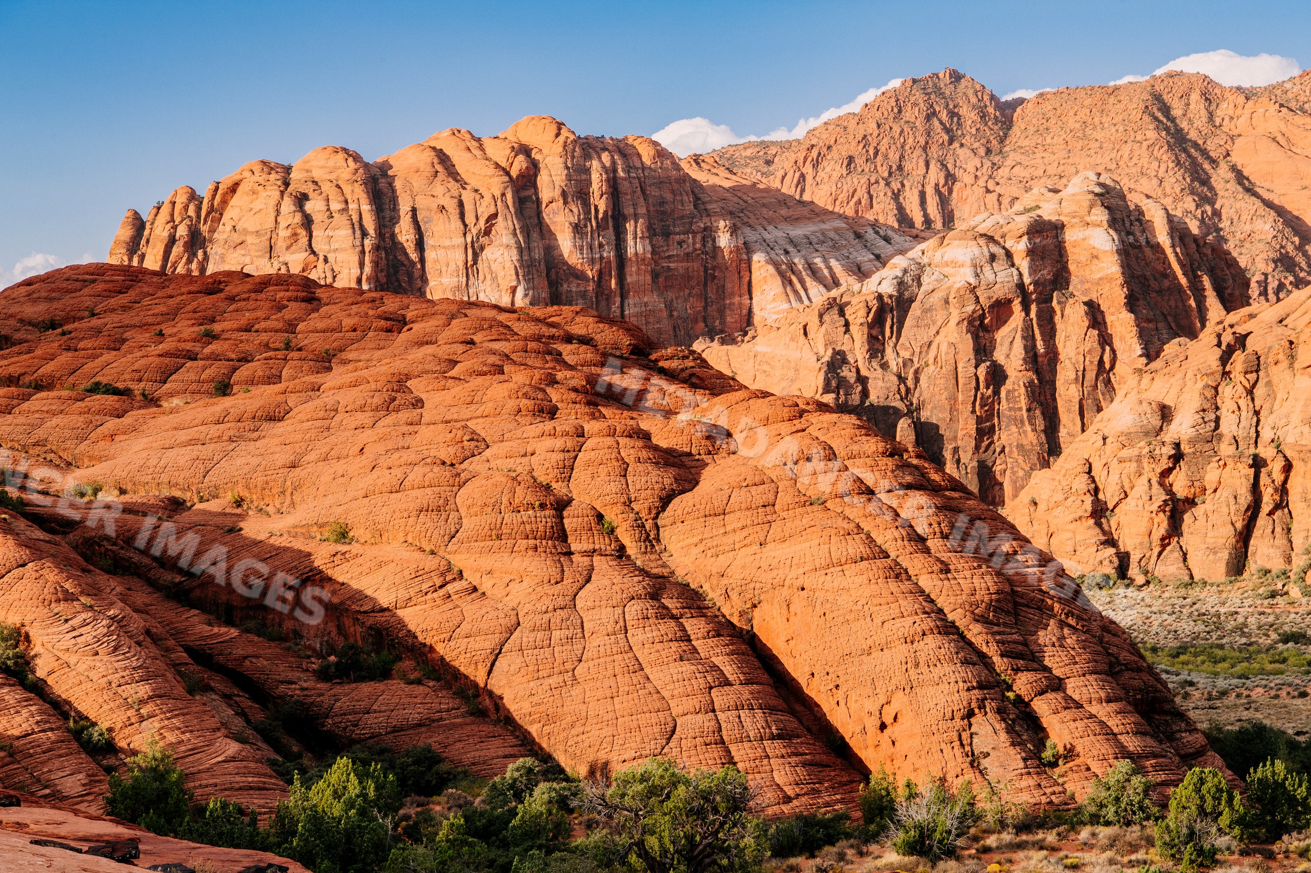 Sunlit red sandstone cliffs and rock formations