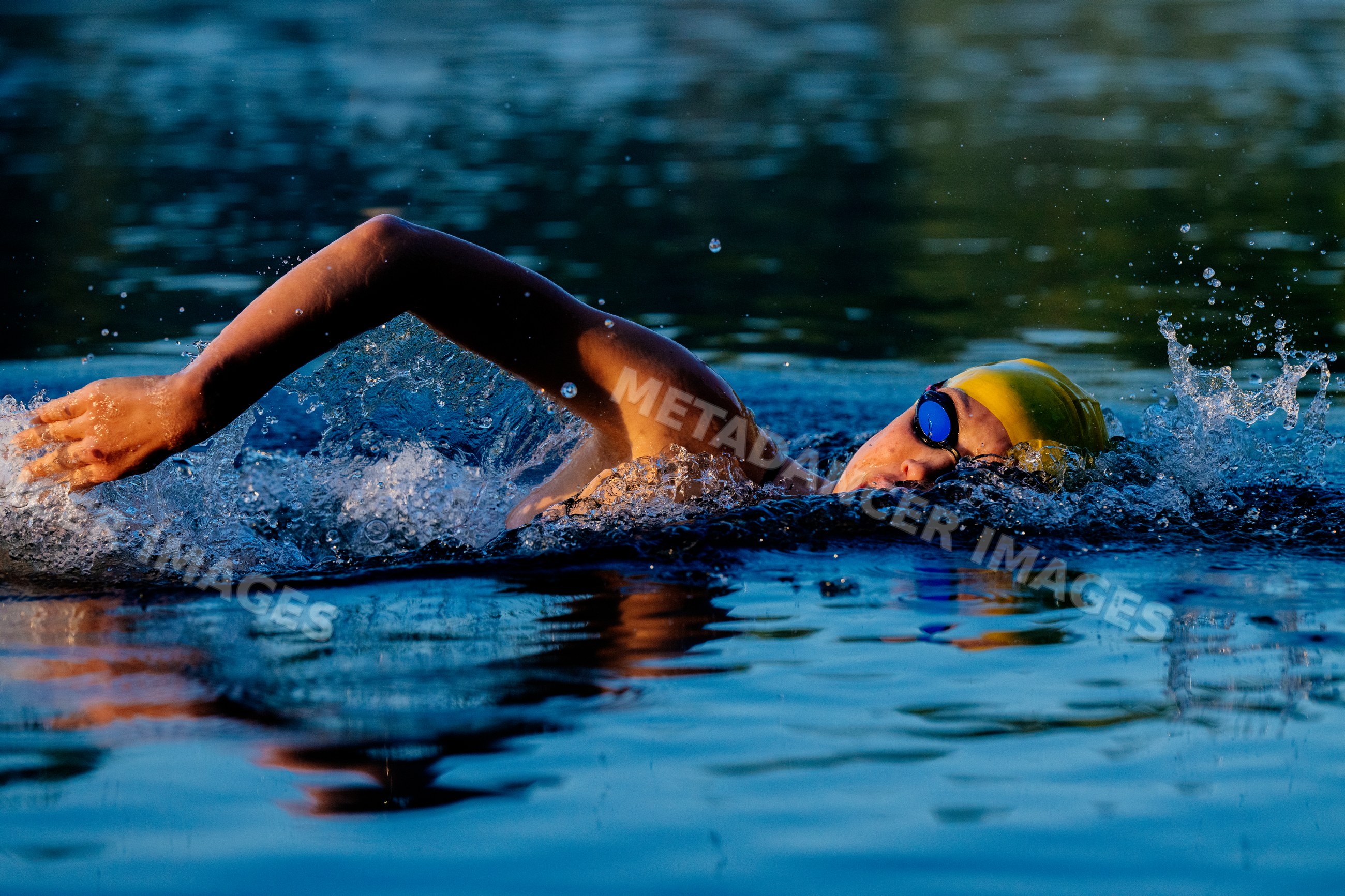 White swimmer performing front crawl in open water