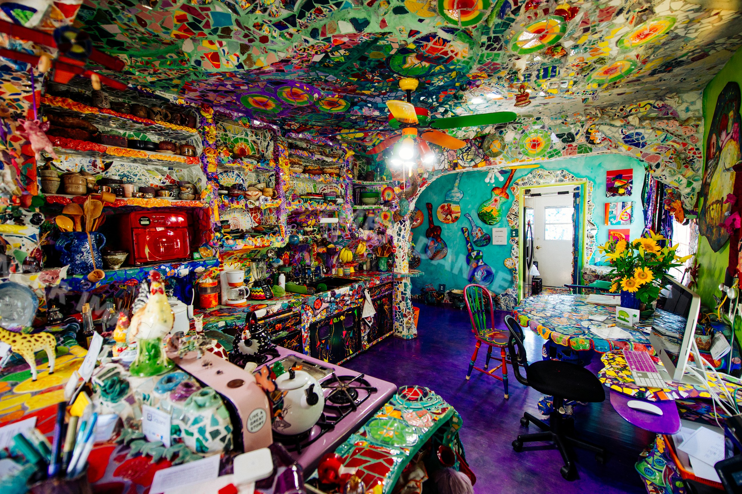Colorful mosaic kitchen with artistic decor and dining area