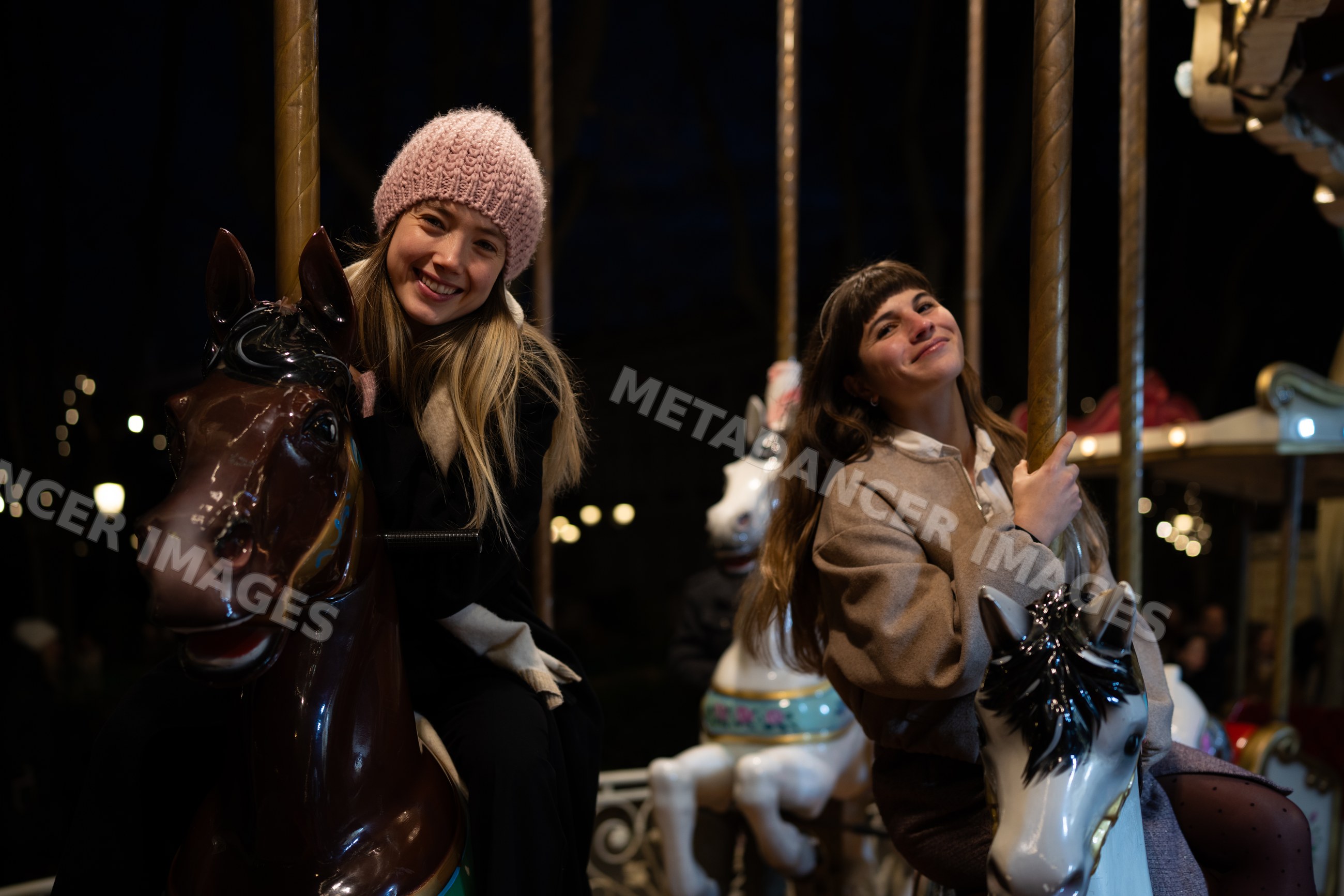Two white women riding carousel horses