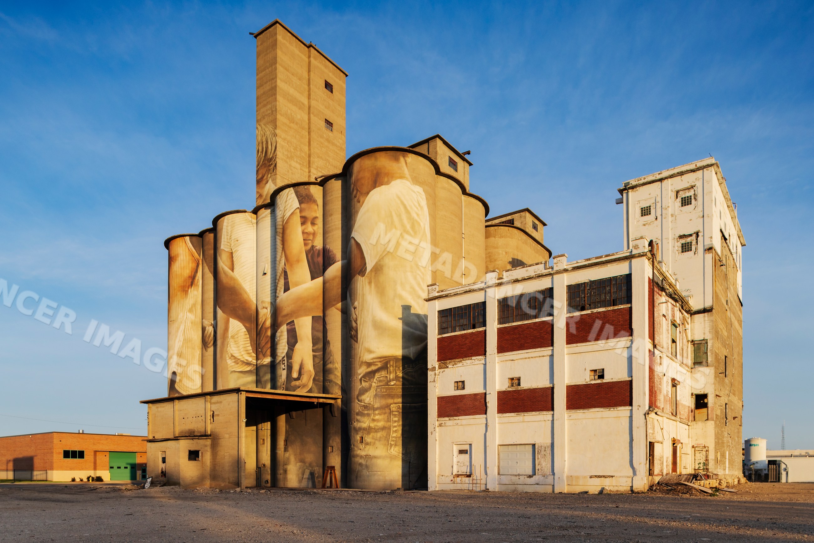 Grain Silo adorned with mural by australian artist guido van helten