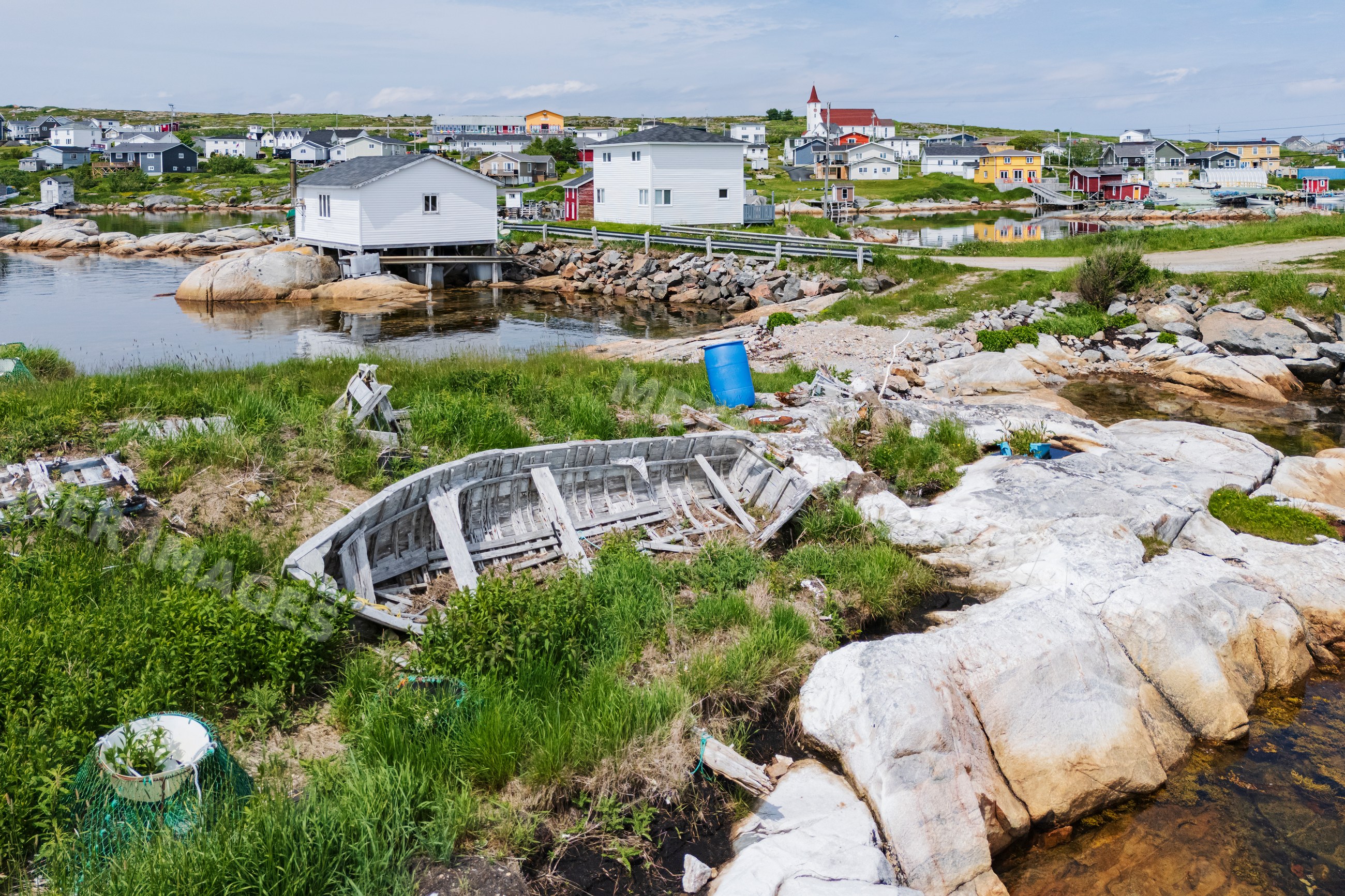 Abandoned wooden boat on rocky shore in greenspond