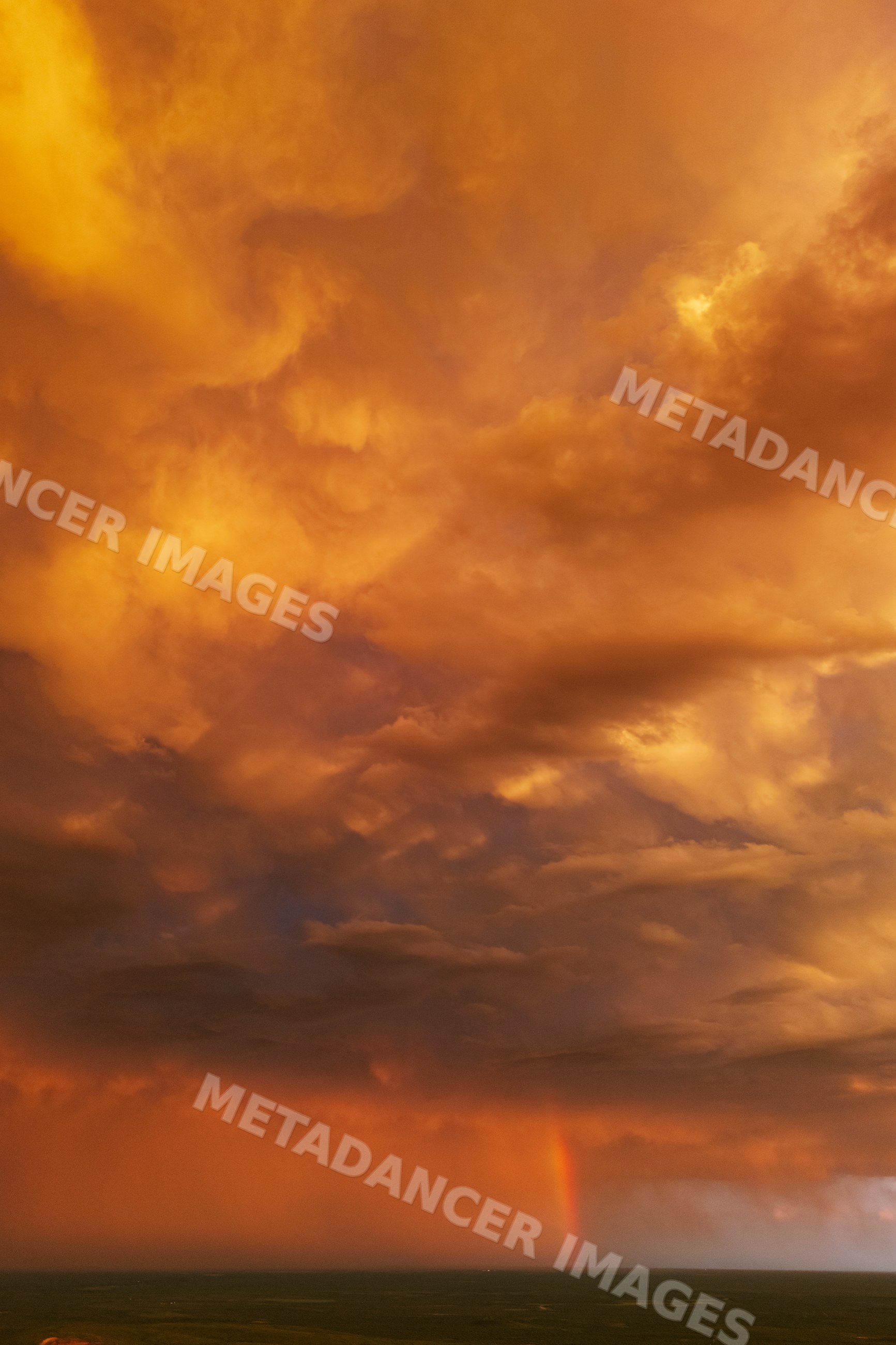 Storm clouds with rainbow at Sunset over uvalde plains