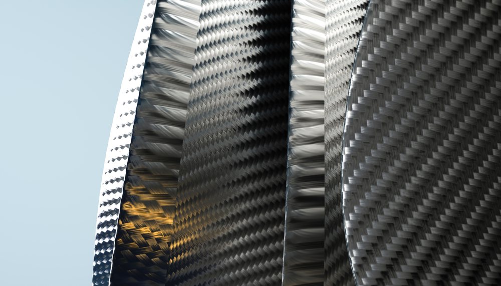 Close-up of curved carbon fiber sheets with reflective weave texture