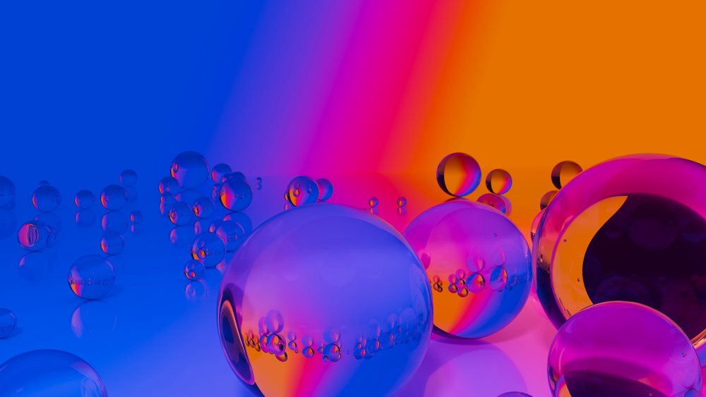 Transparent glass spheres reflecting vibrant blue, purple