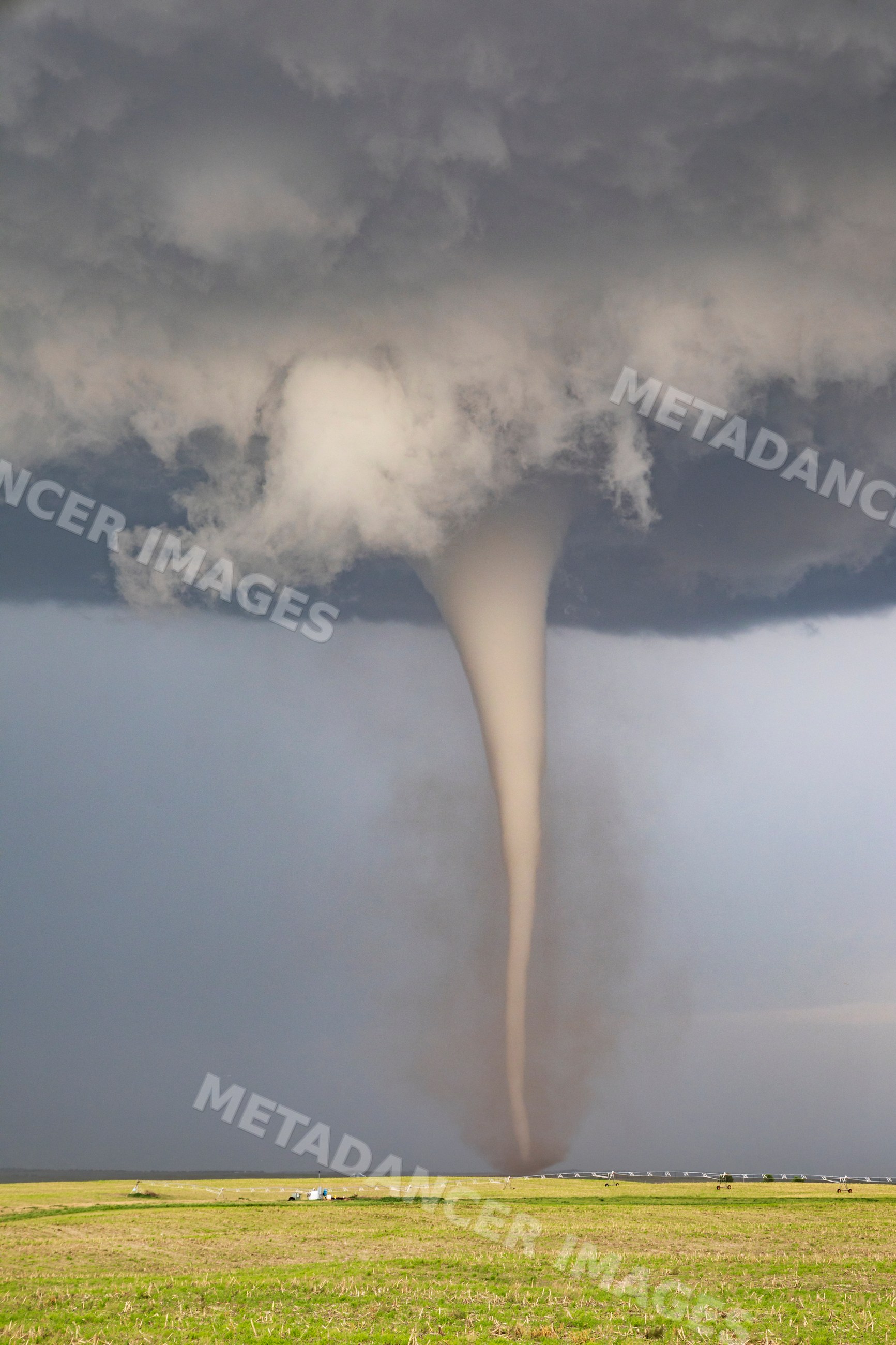 Fully Condensed Tornado touching down over farmland