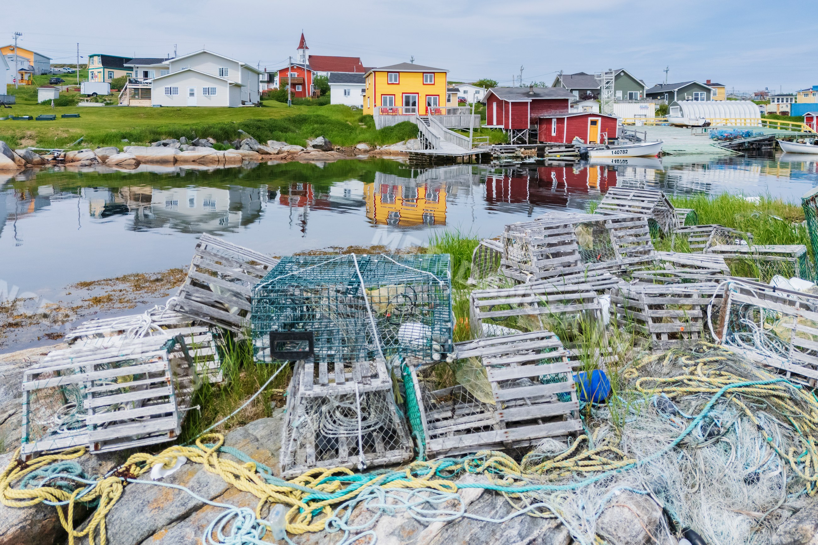 Fishing harbour with stacked lobster traps and ropes on rocks