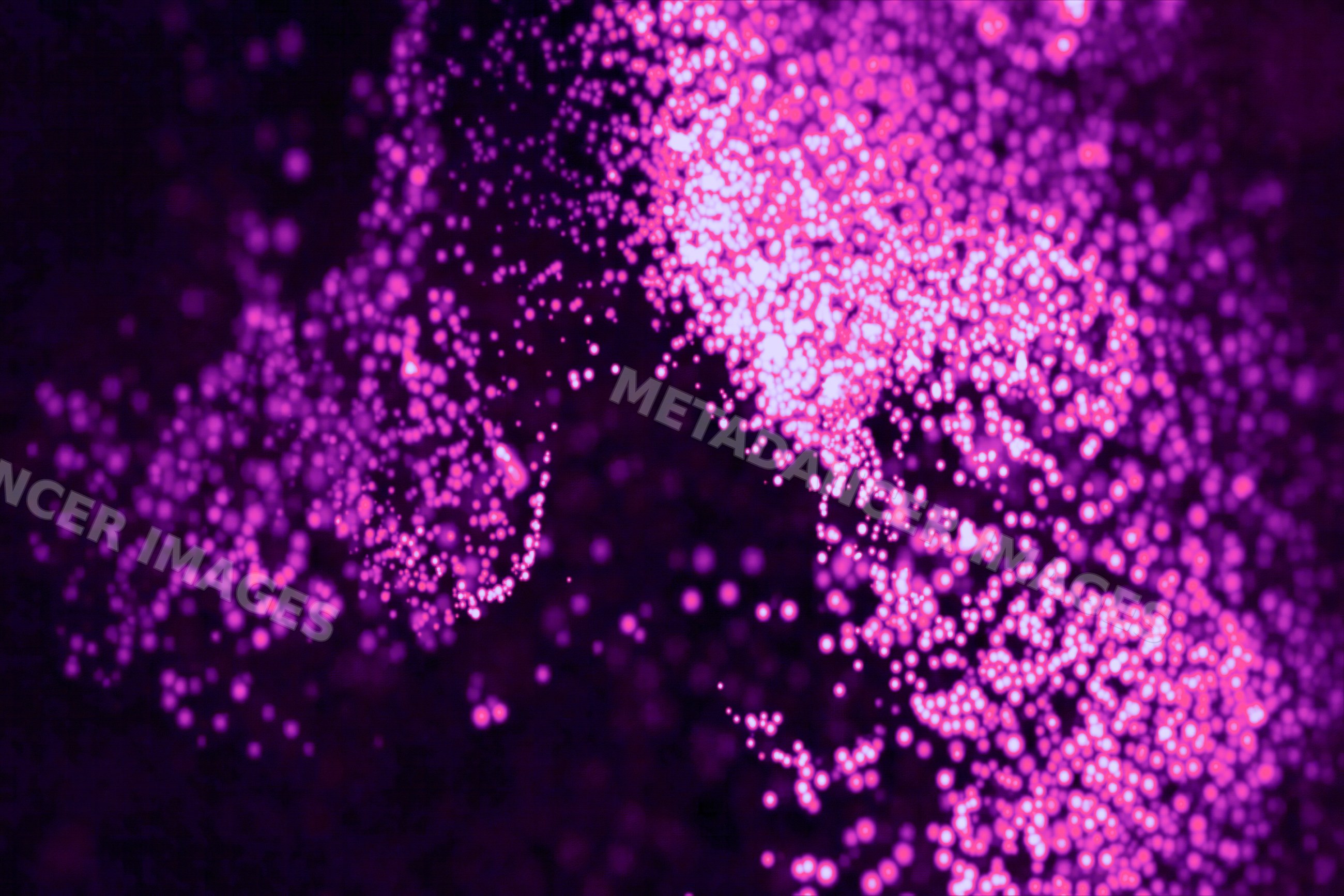 Close-up of glowing purple particles forming an abstract light pattern