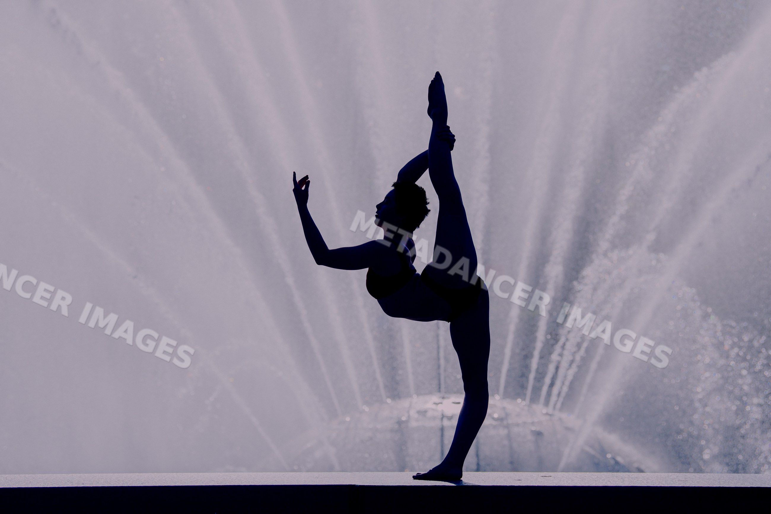 Silhouette of white woman balancing