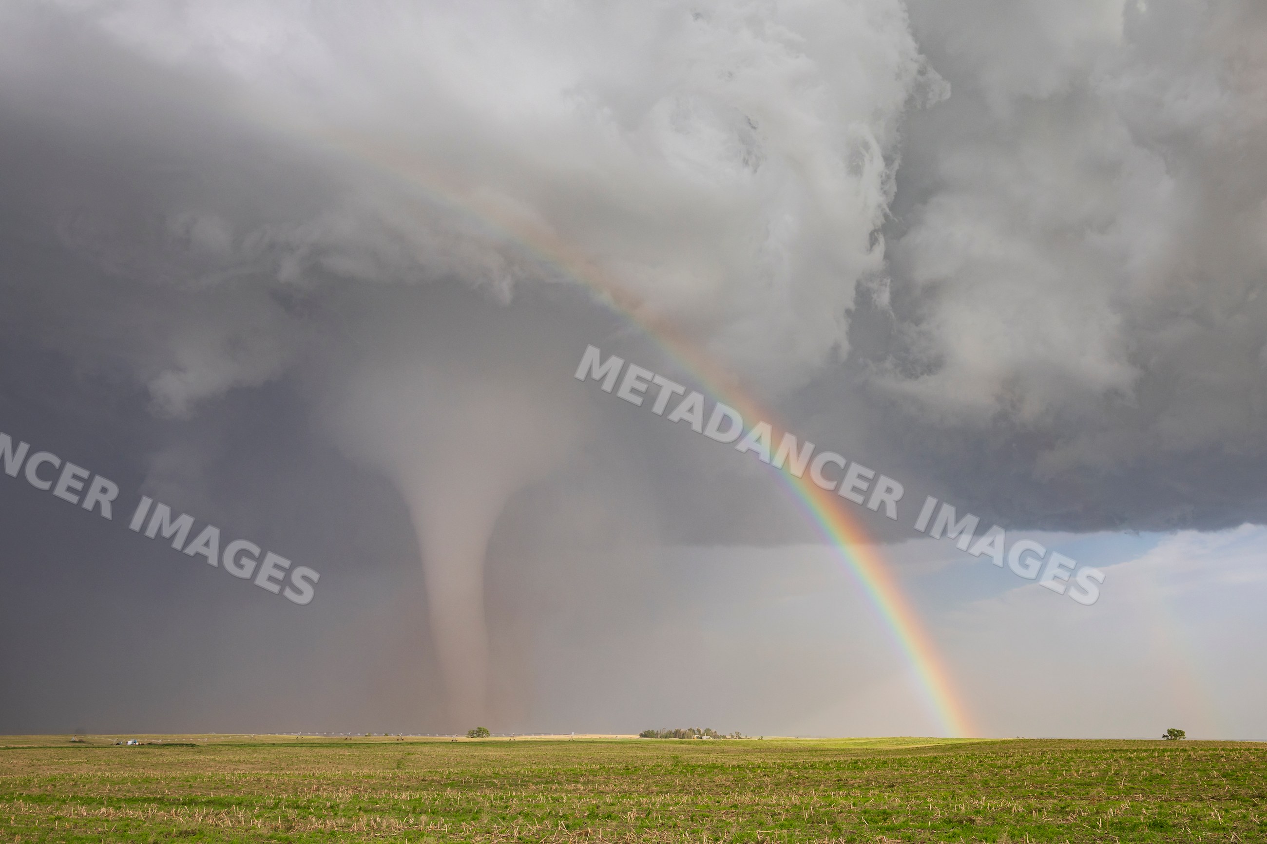Tornado with Double Rainbow over grassy plains in dickens nebraska