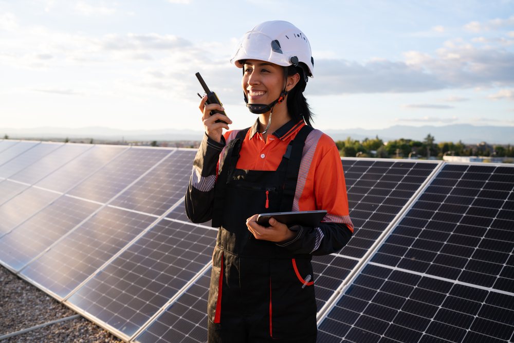 Hispanic woman engineer using walkie talkie