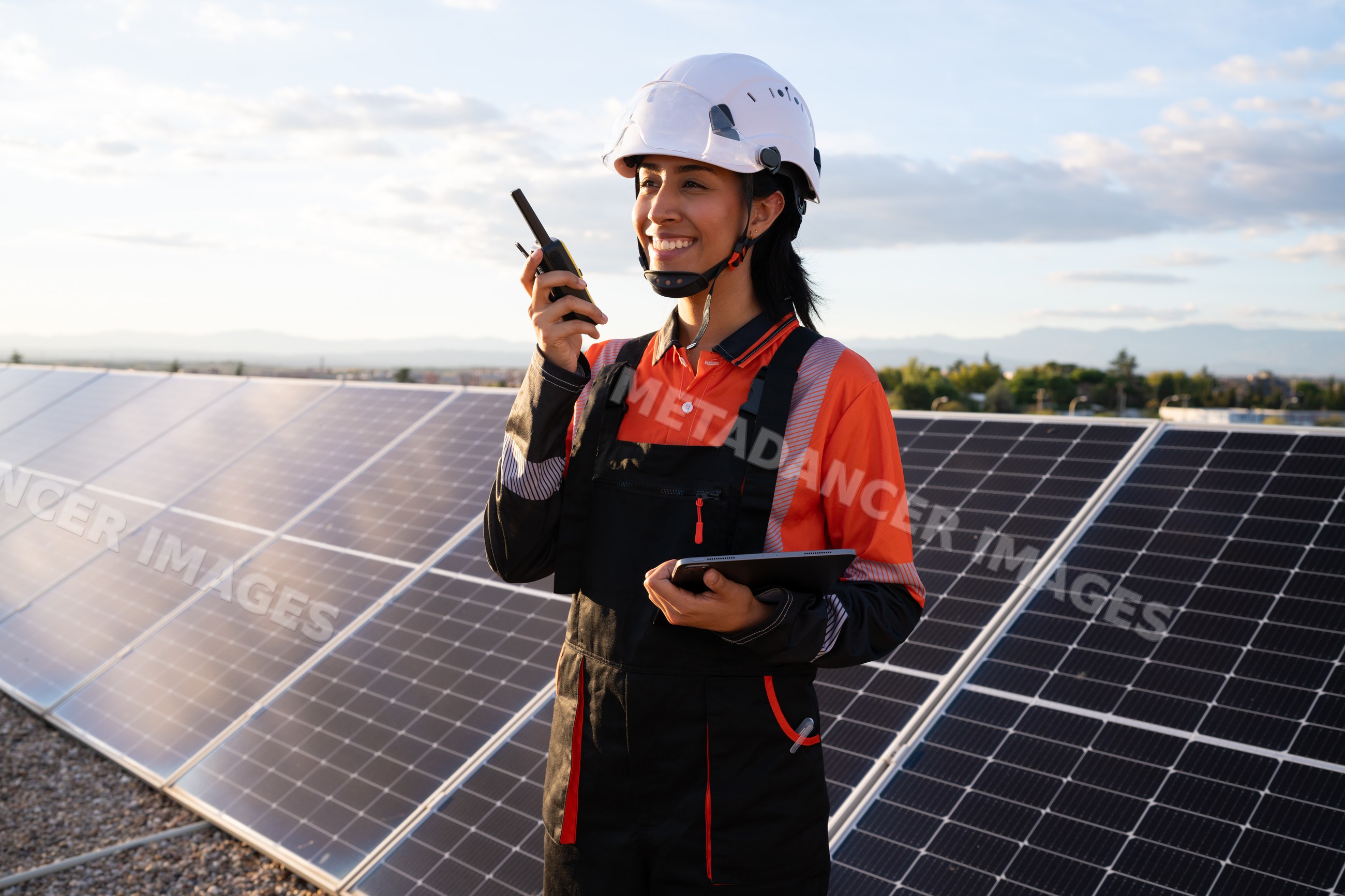 Hispanic woman engineer using walkie talkie