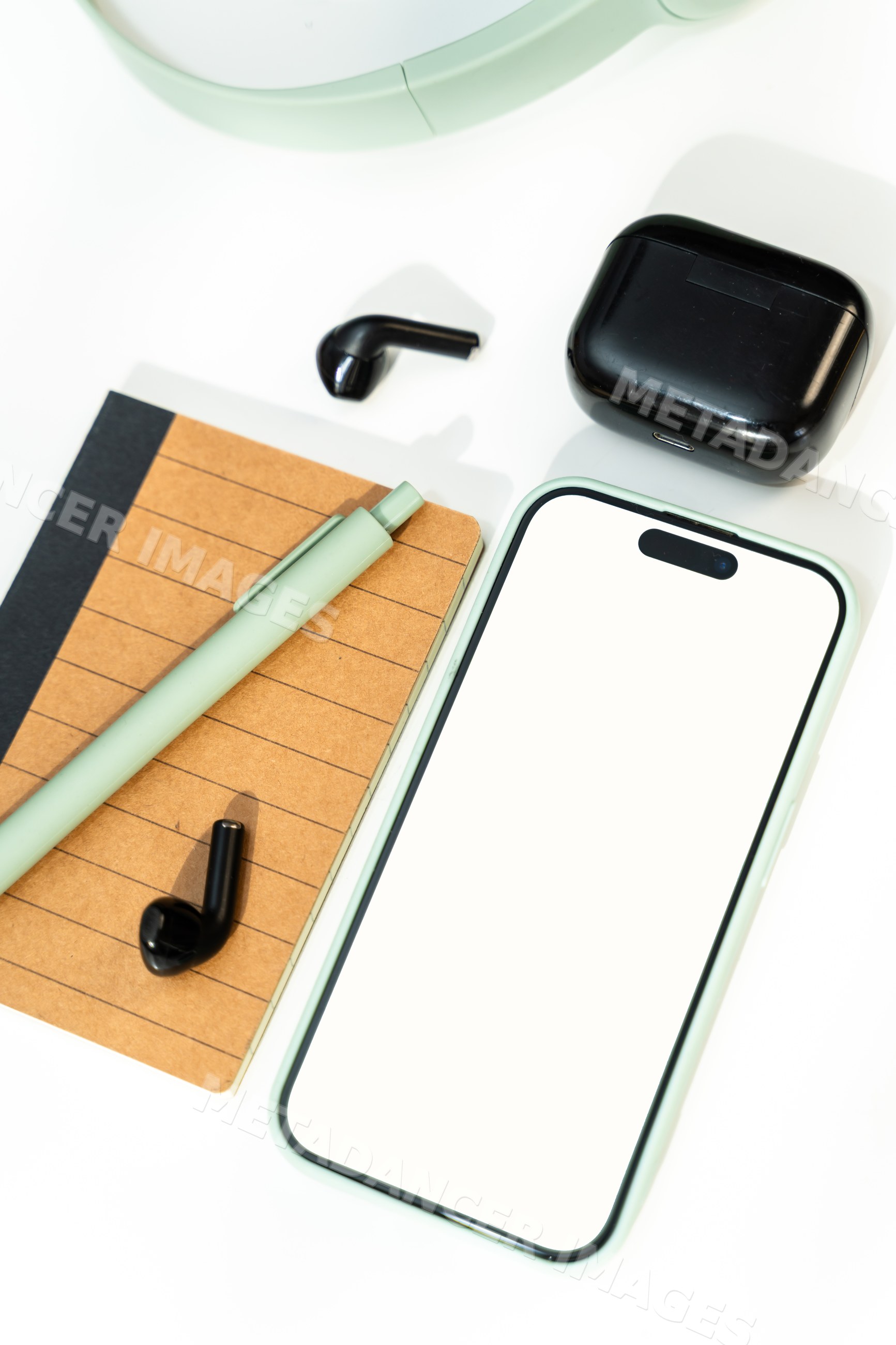 Smartphone with wireless earbuds, notebook