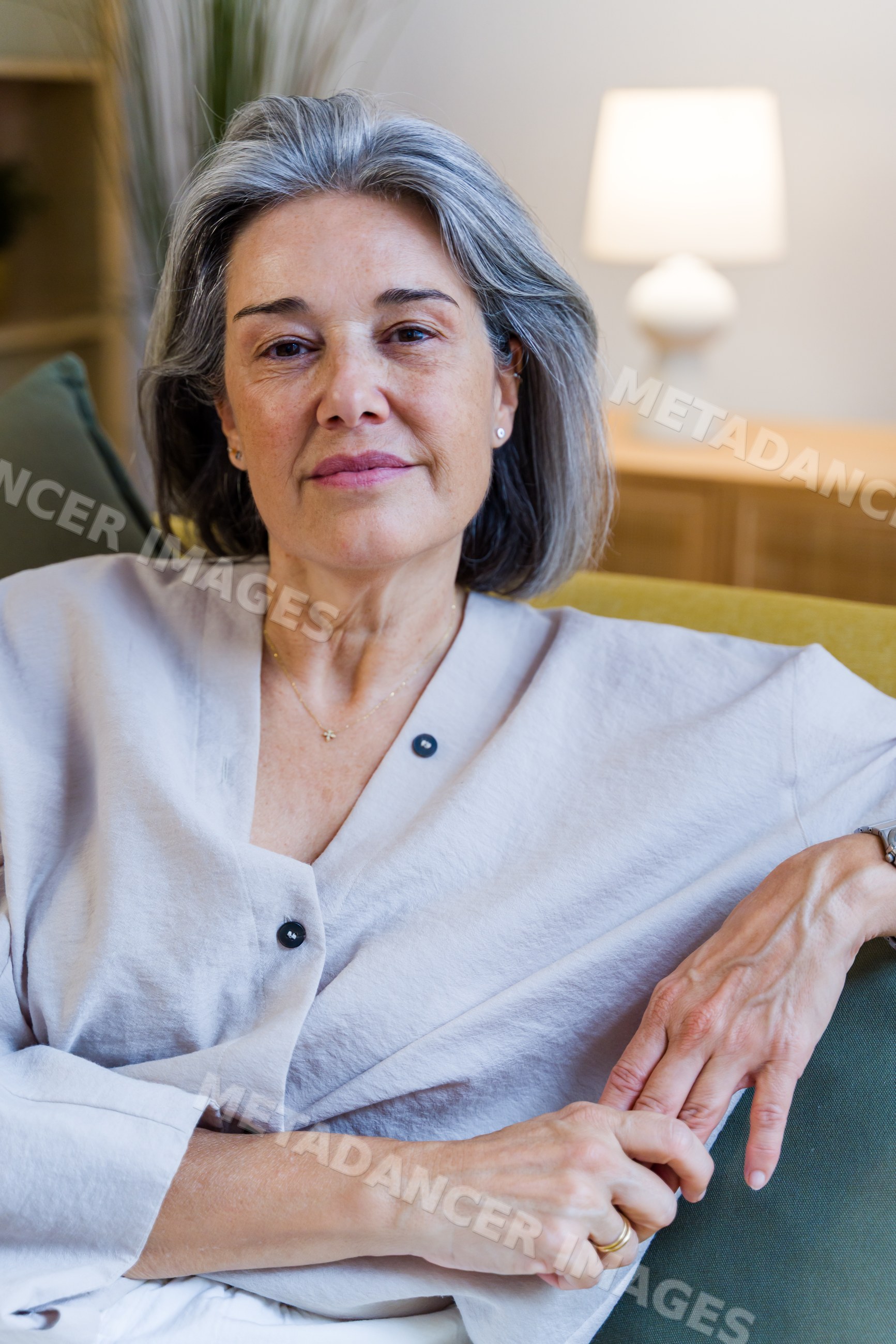 Mature white woman relaxing on sofa indoors